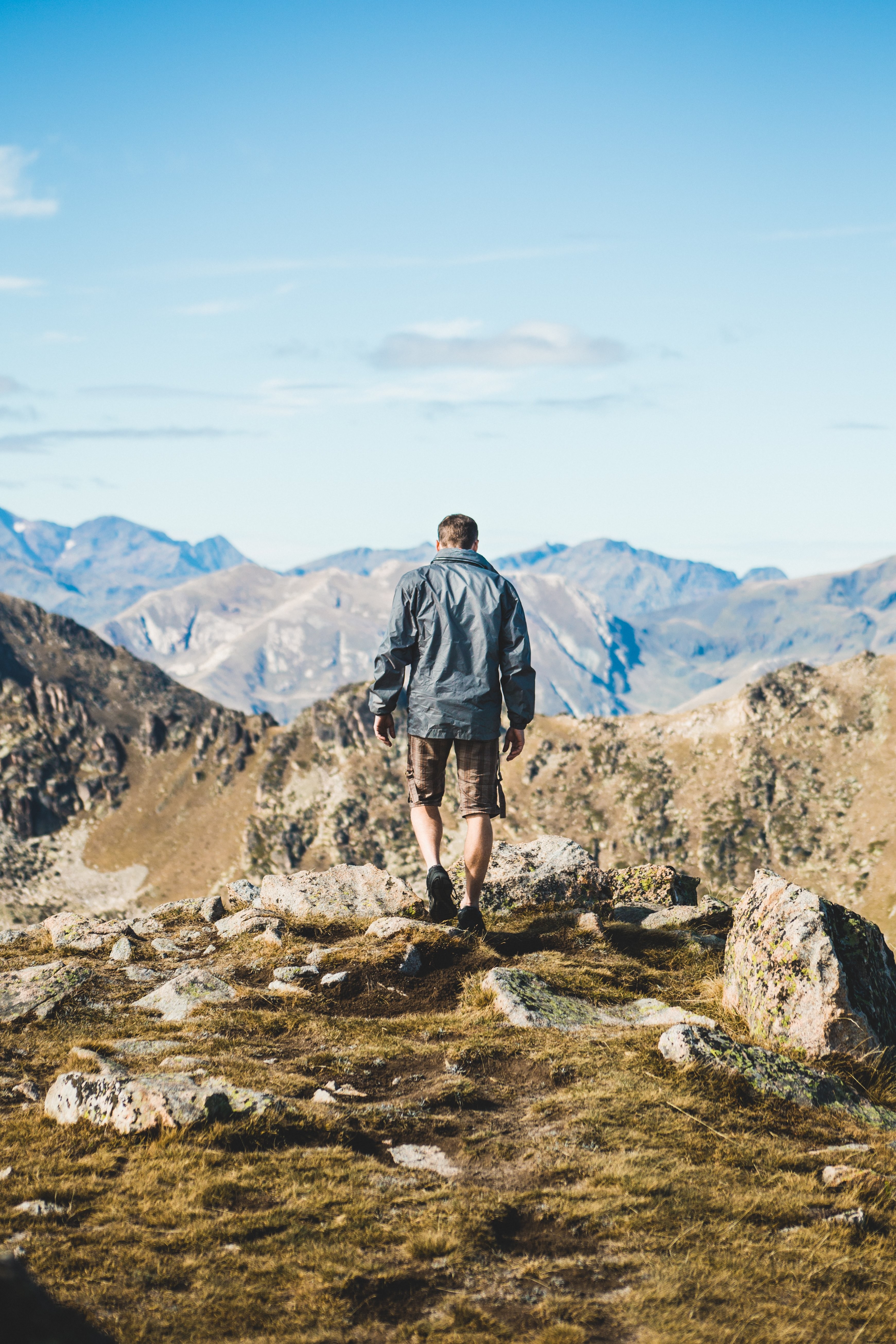 Stunning Photo of Man Hiking Through Majestic Mountains