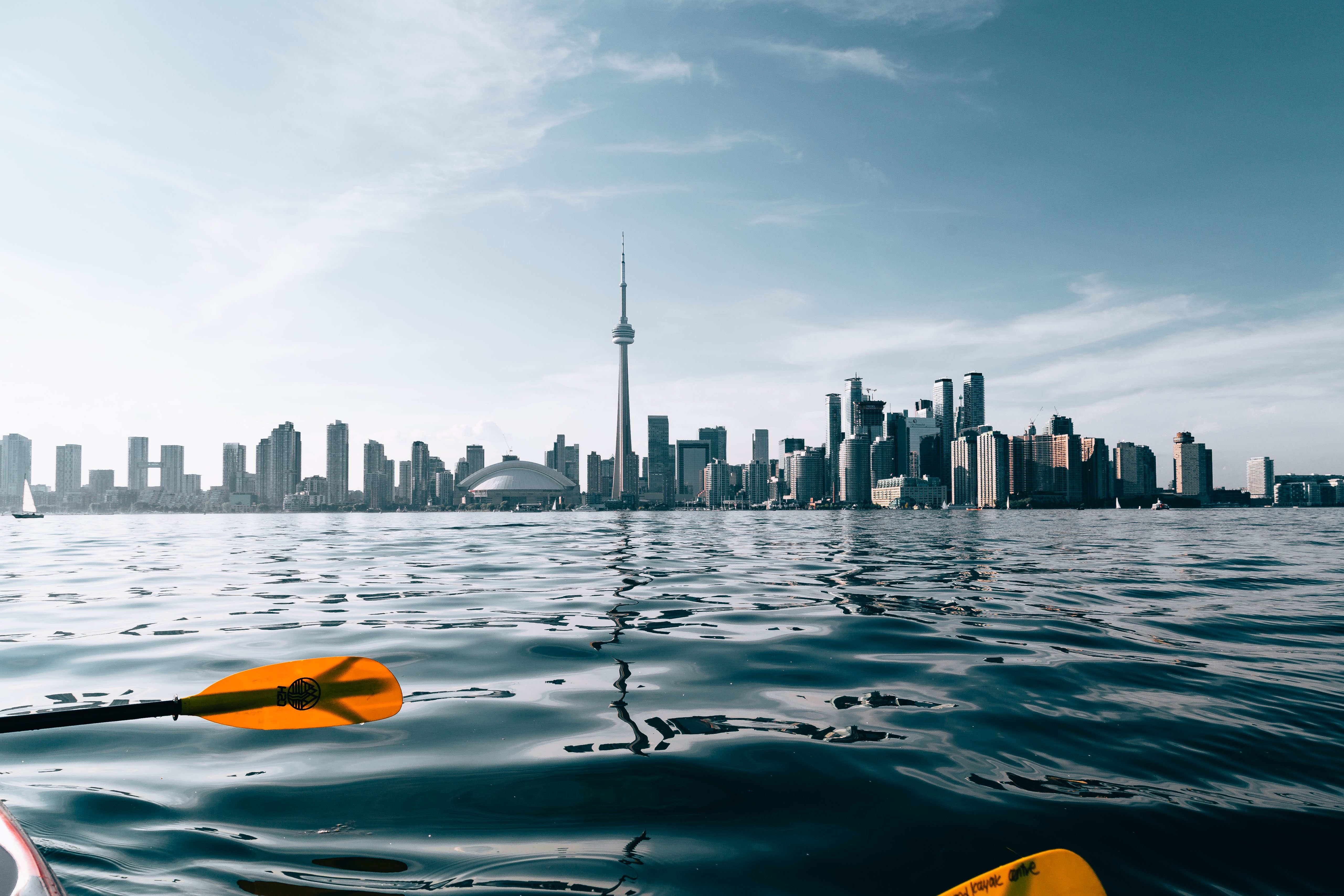 Stunning Paddling Scene Against Vibrant City Skyline