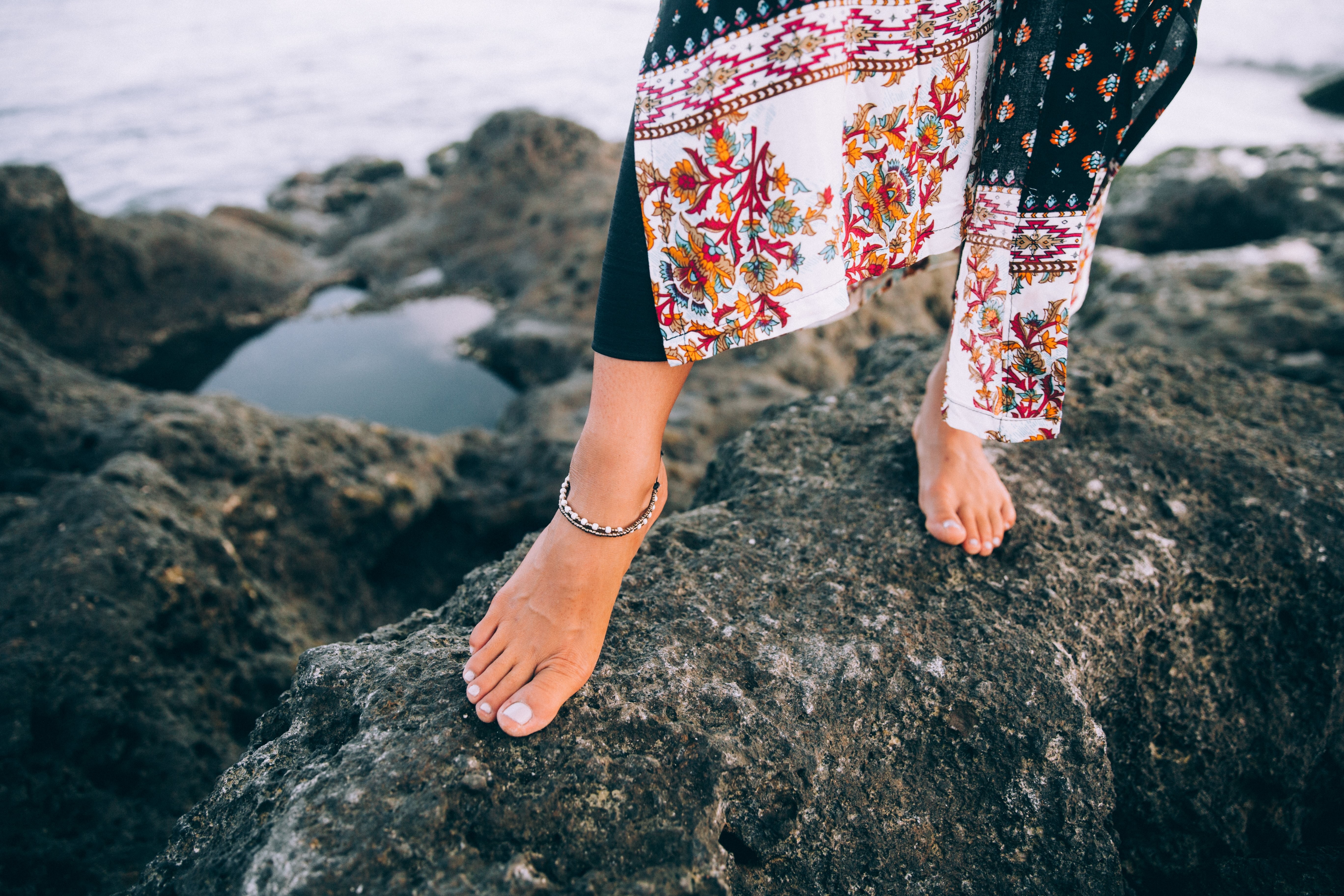 Stunning Photo: Elegant Woman in Flowing Beach Robe Strolling Along the Shore