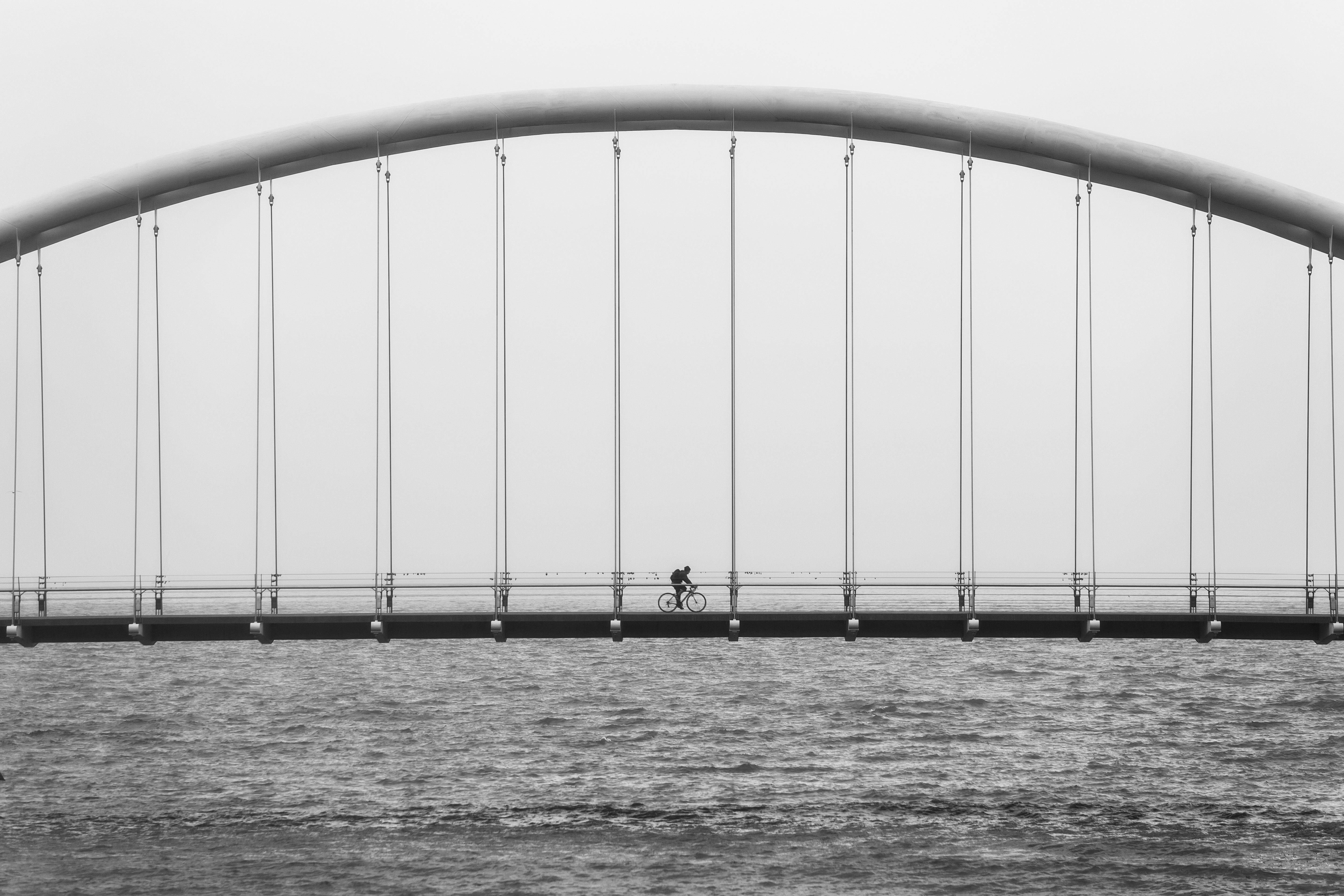 Stunning Photo: Cyclist Biking Over Majestic Bridge