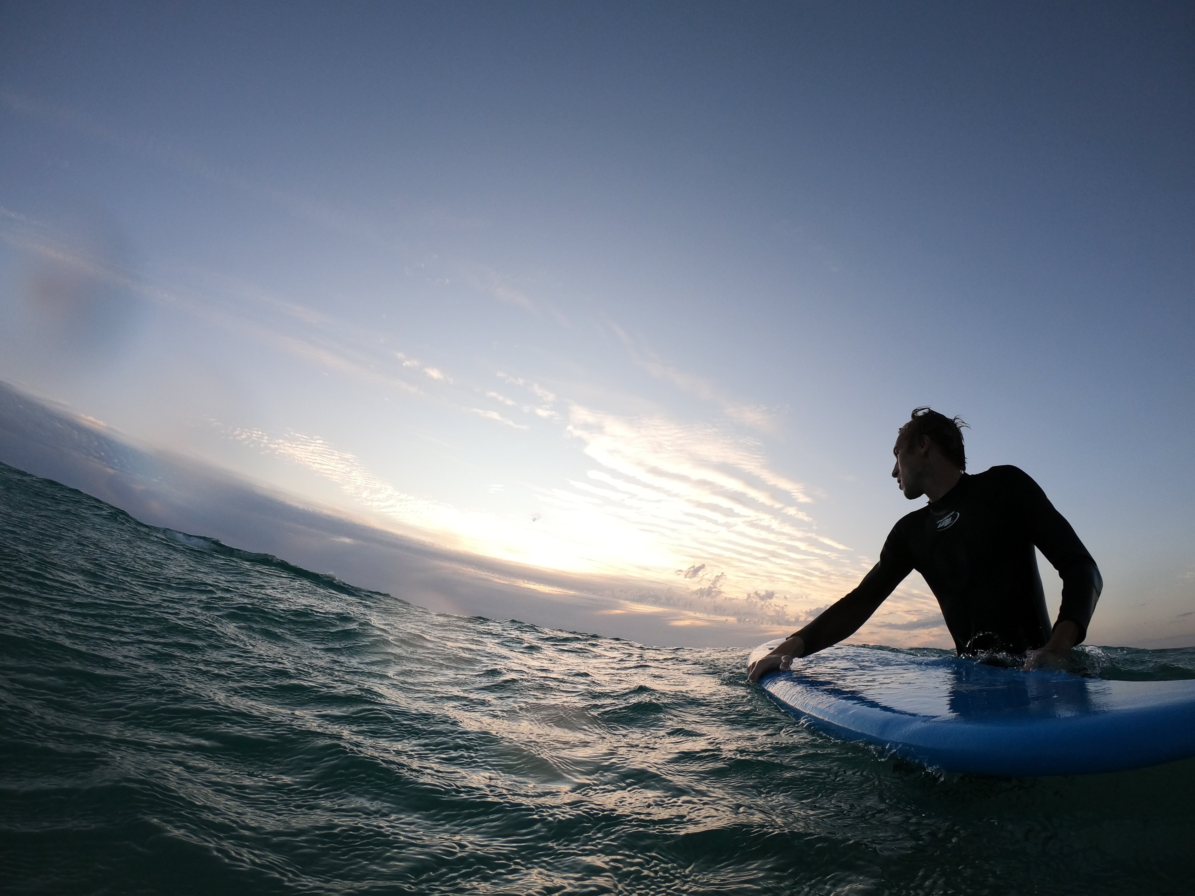 Stunning Photo: Surfer Standing in Choppy Ocean Waves Holding Surfboard