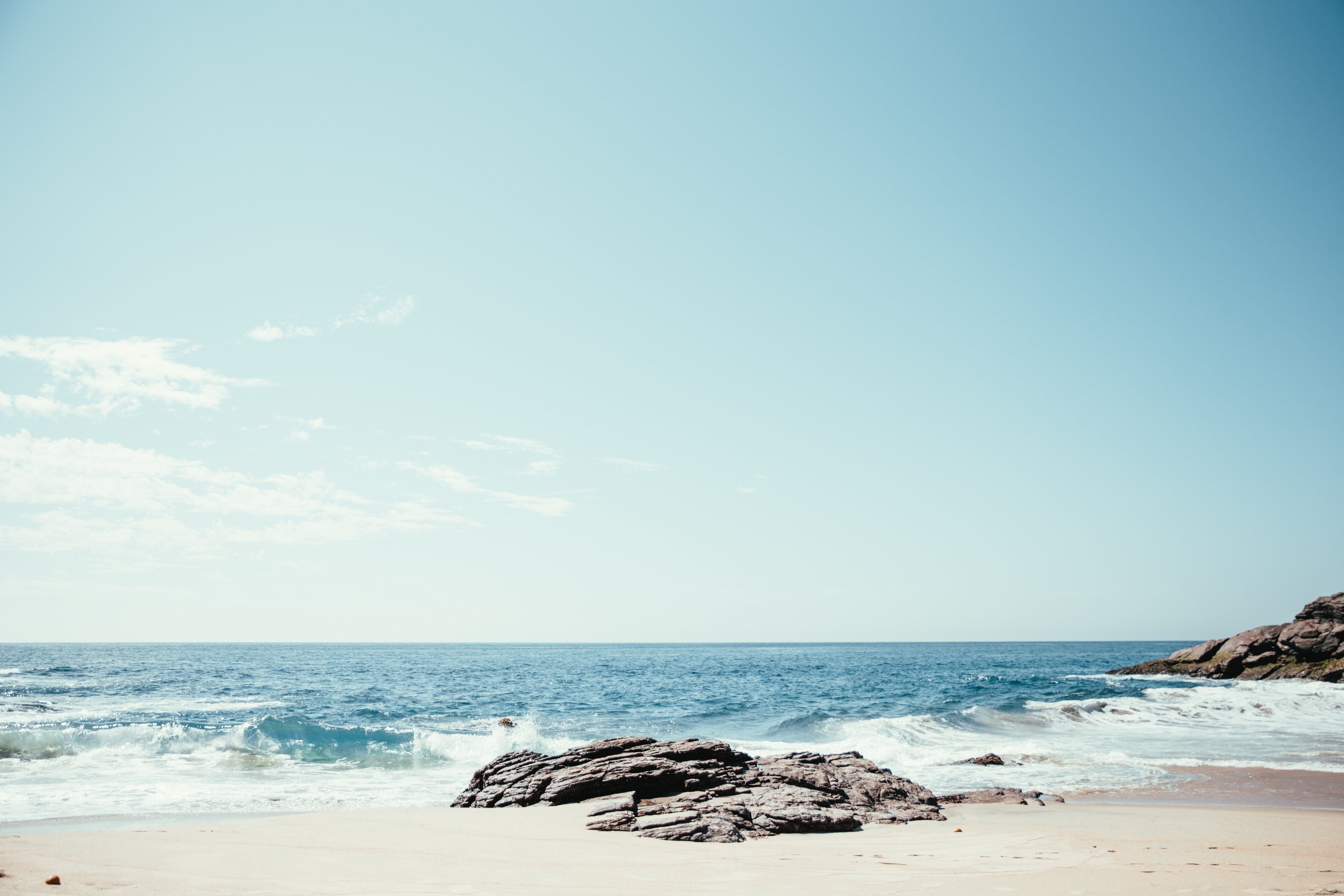 Stunning Waves Crashing on Rocks and Sandy Shore – Breathtaking Coastal Photo