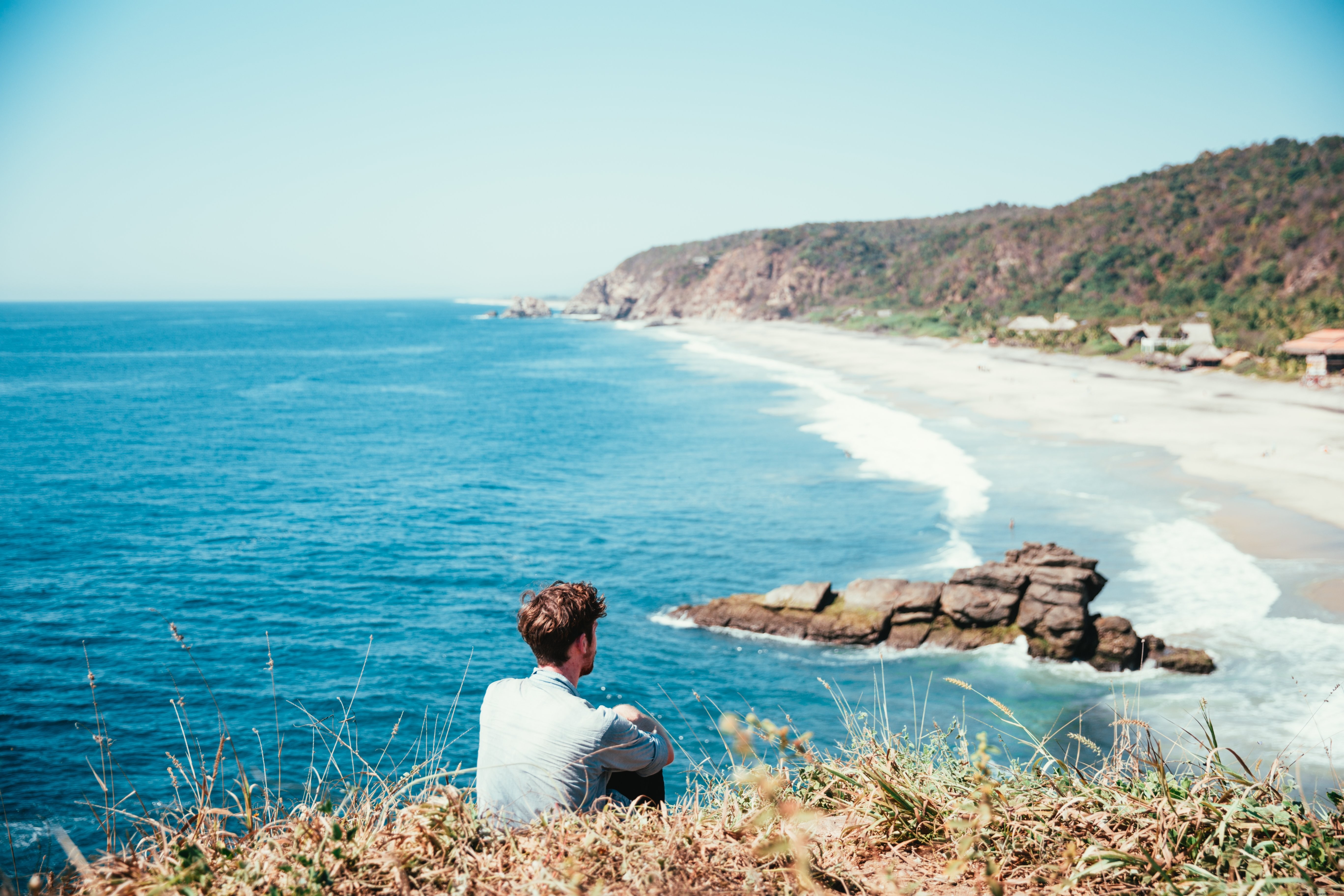 Serene Man in Deep Reflection by the Ocean - Stunning Coastal Photo