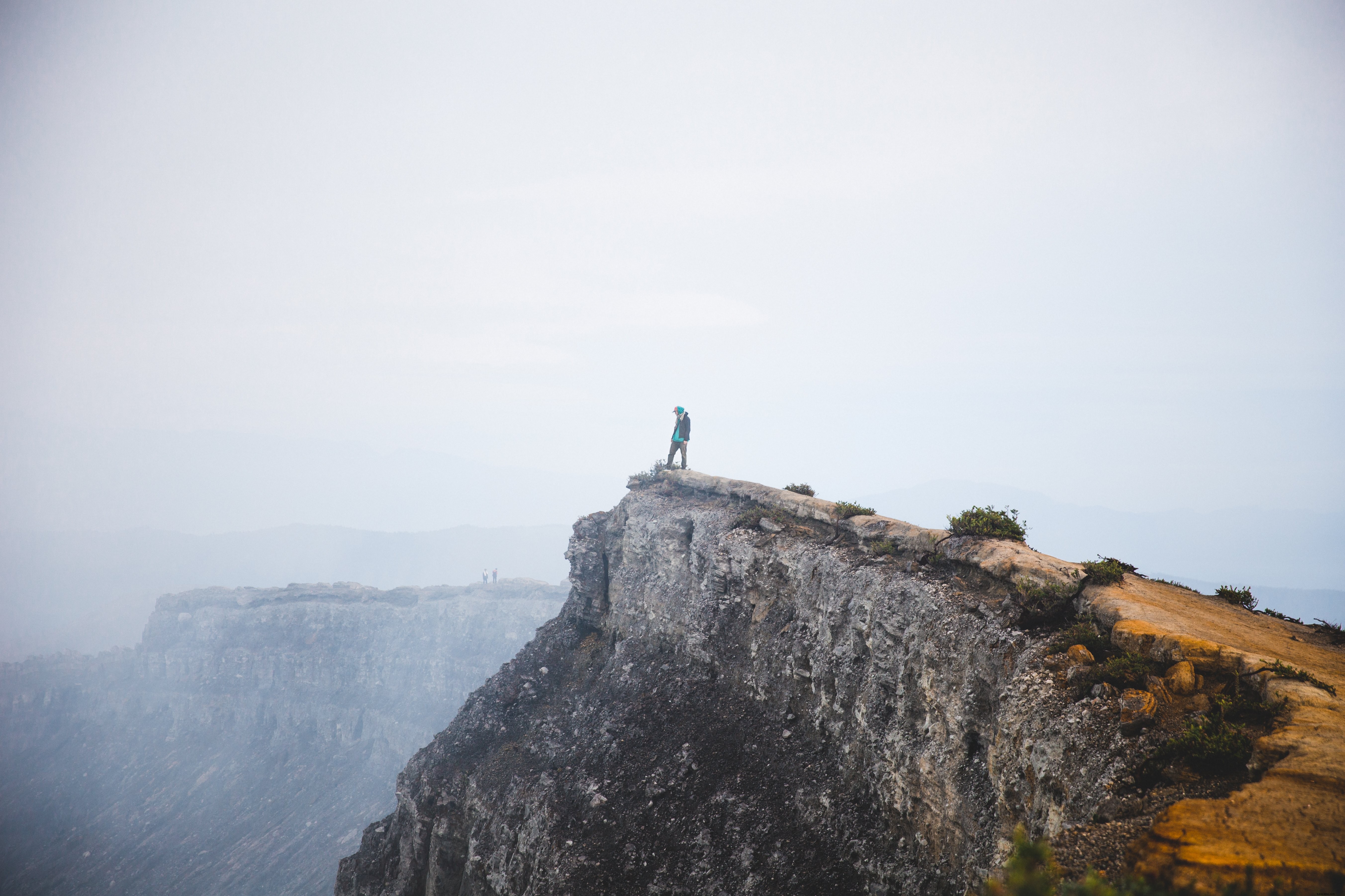 Daring Adventurer on Cliff Edge: Breathtaking Photography