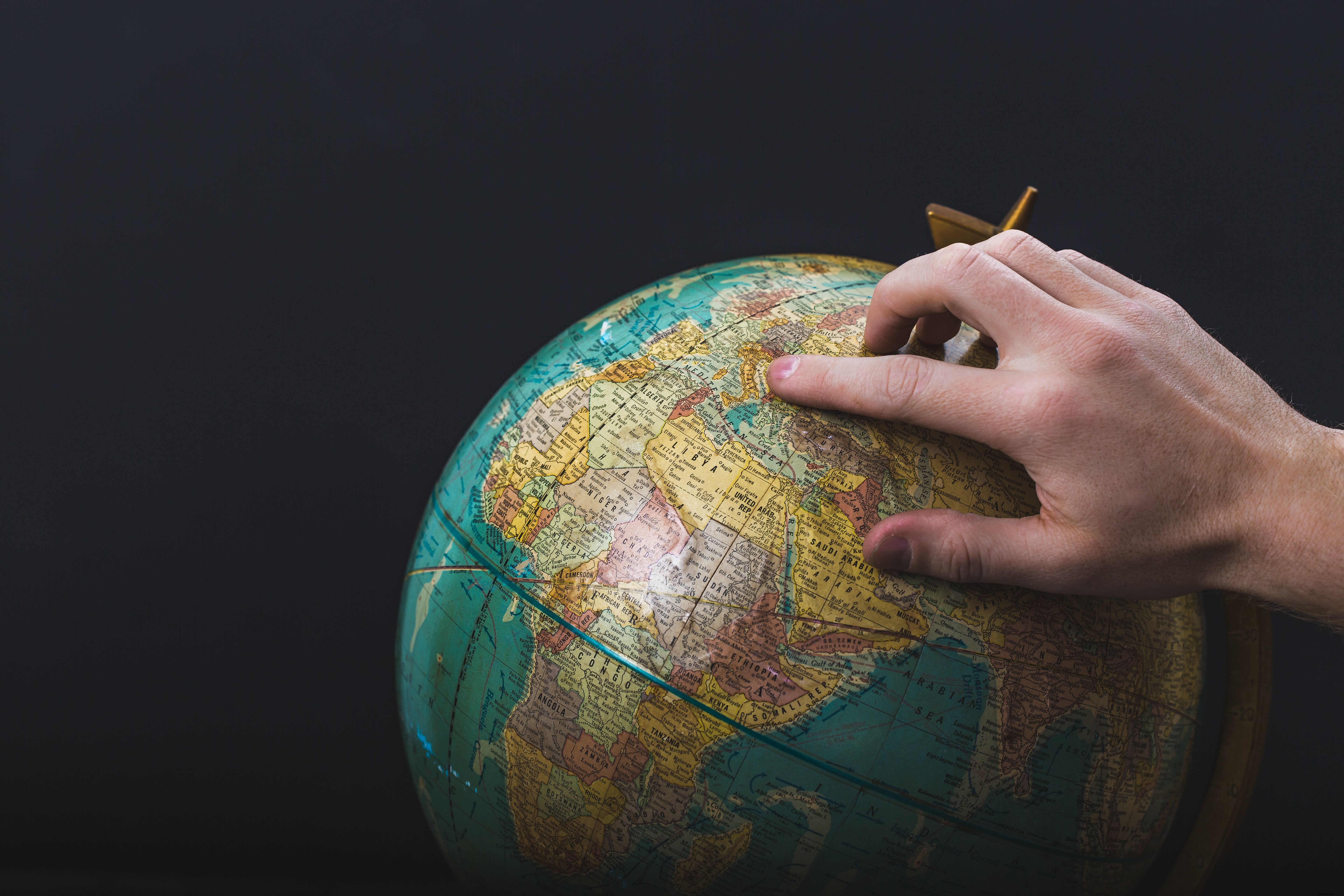 Captivating Photo: Hand Pointing to Globe