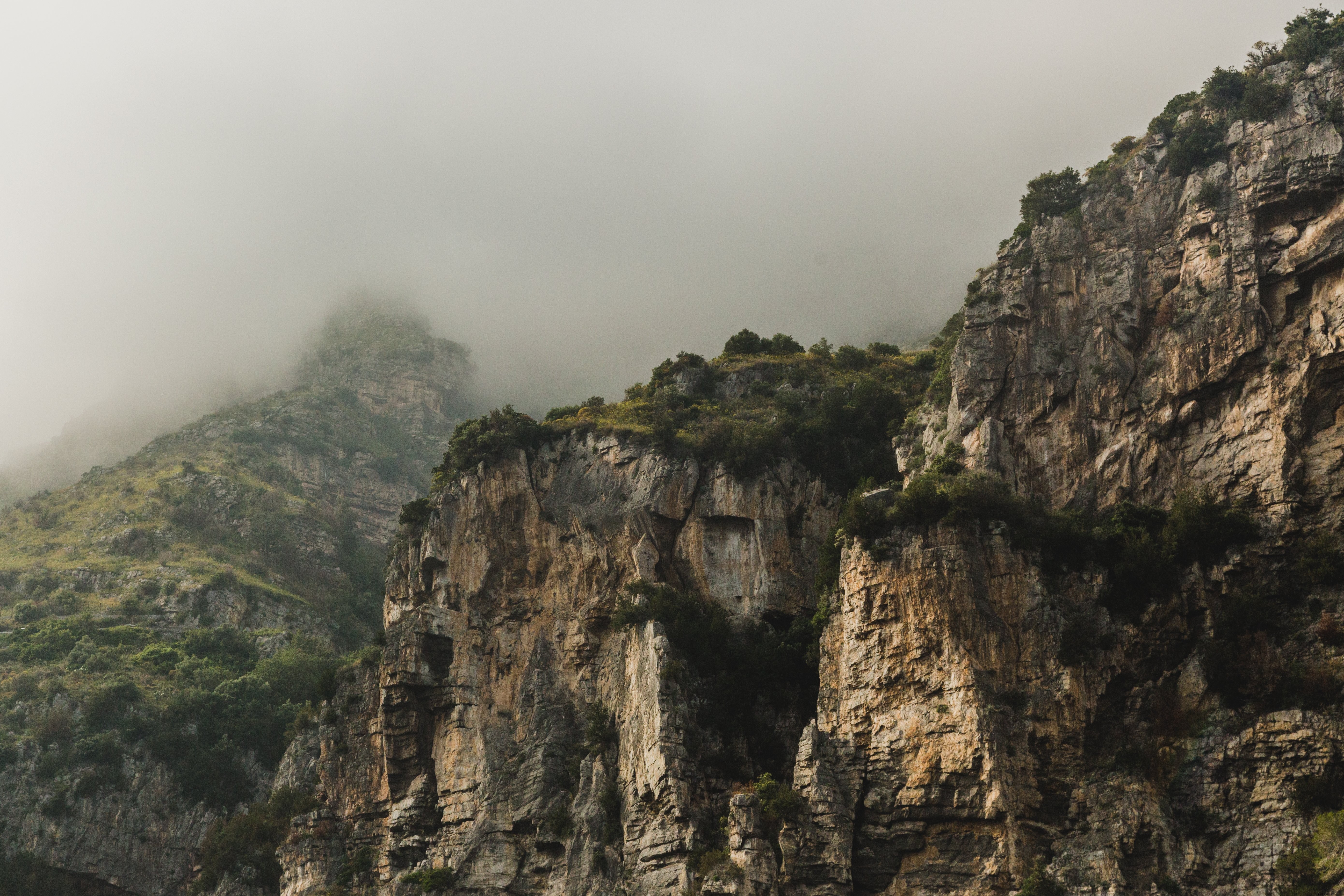 Majestic Cliffs Against a Mystical Foggy Backdrop – Stunning Landscape Photo