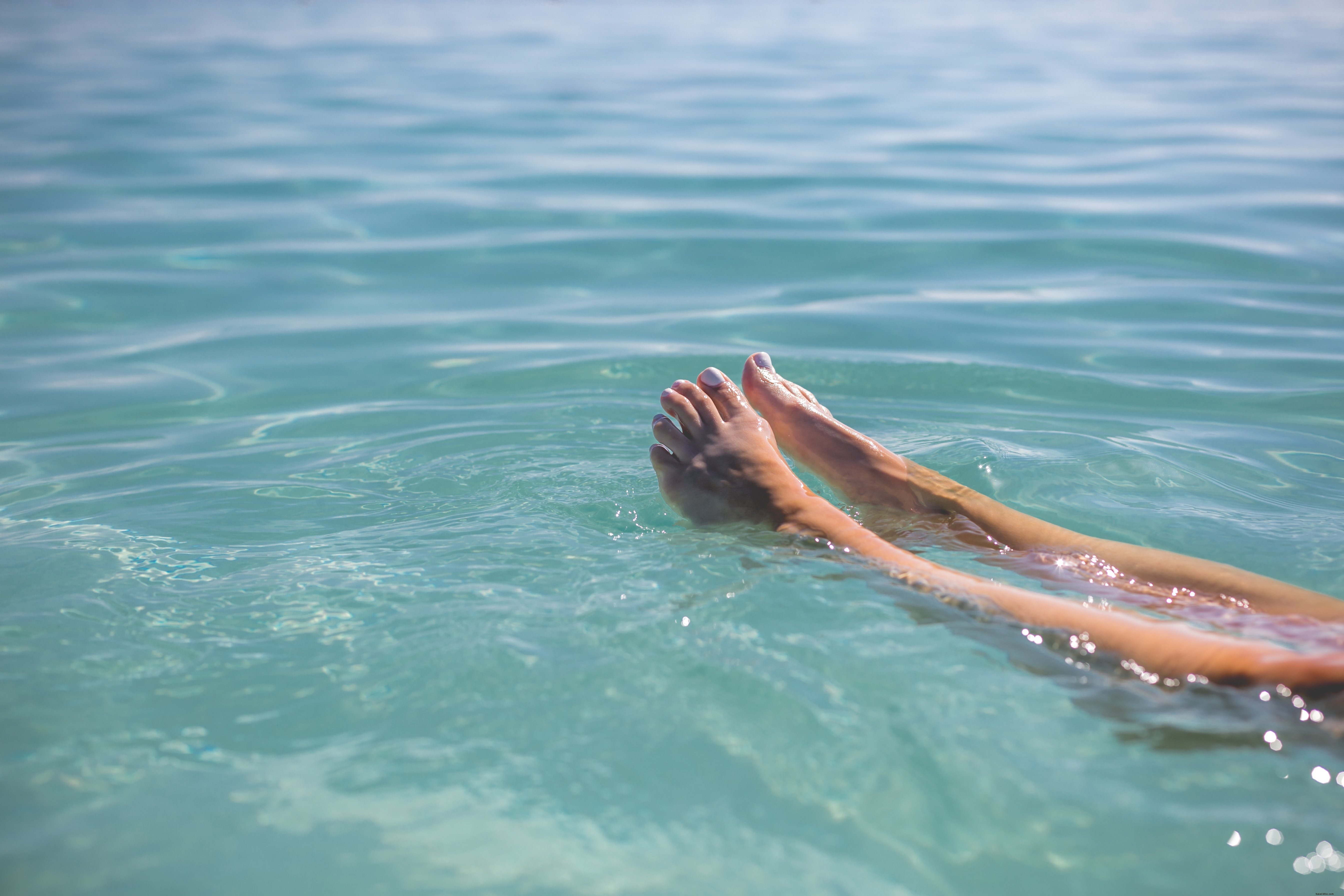 Serene Feet Floating in Crystal Blue Water – Stunning High-Res Photo