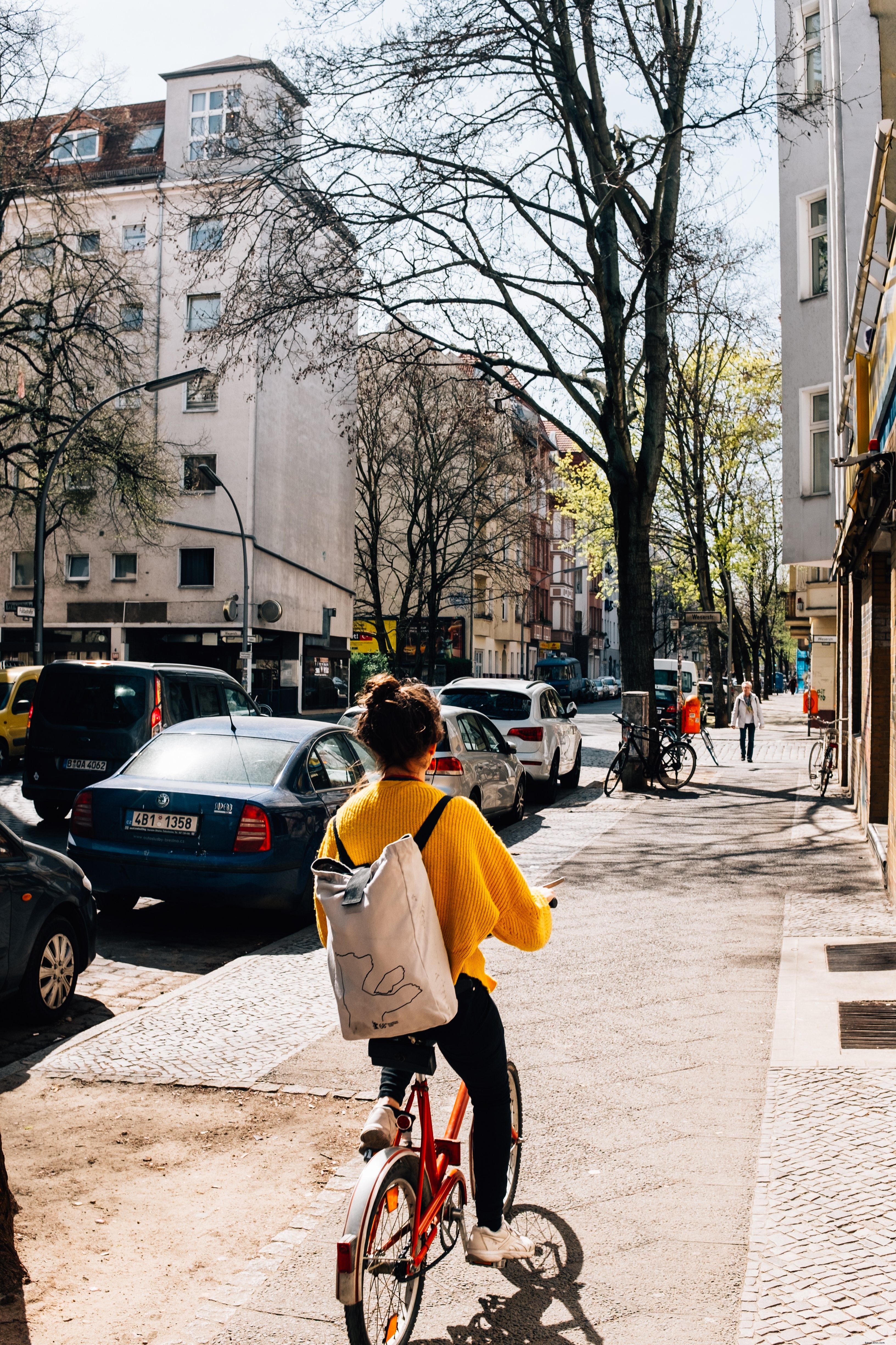 Captivating Street Rider: Stunning Photo of a Woman Cycling Down the Urban Lane