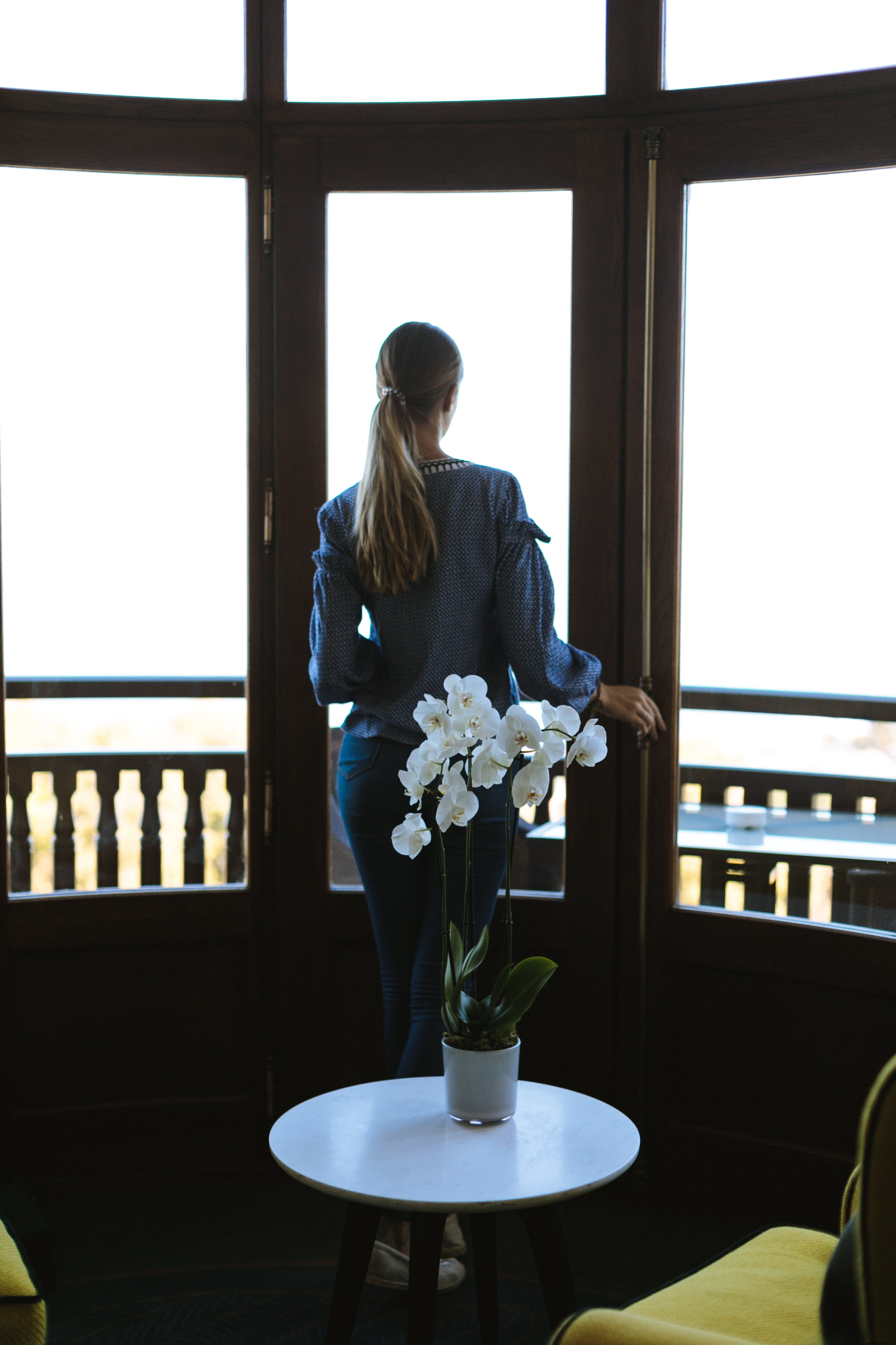 Elegant Orchid Decor: Woman Savoring a Serene View