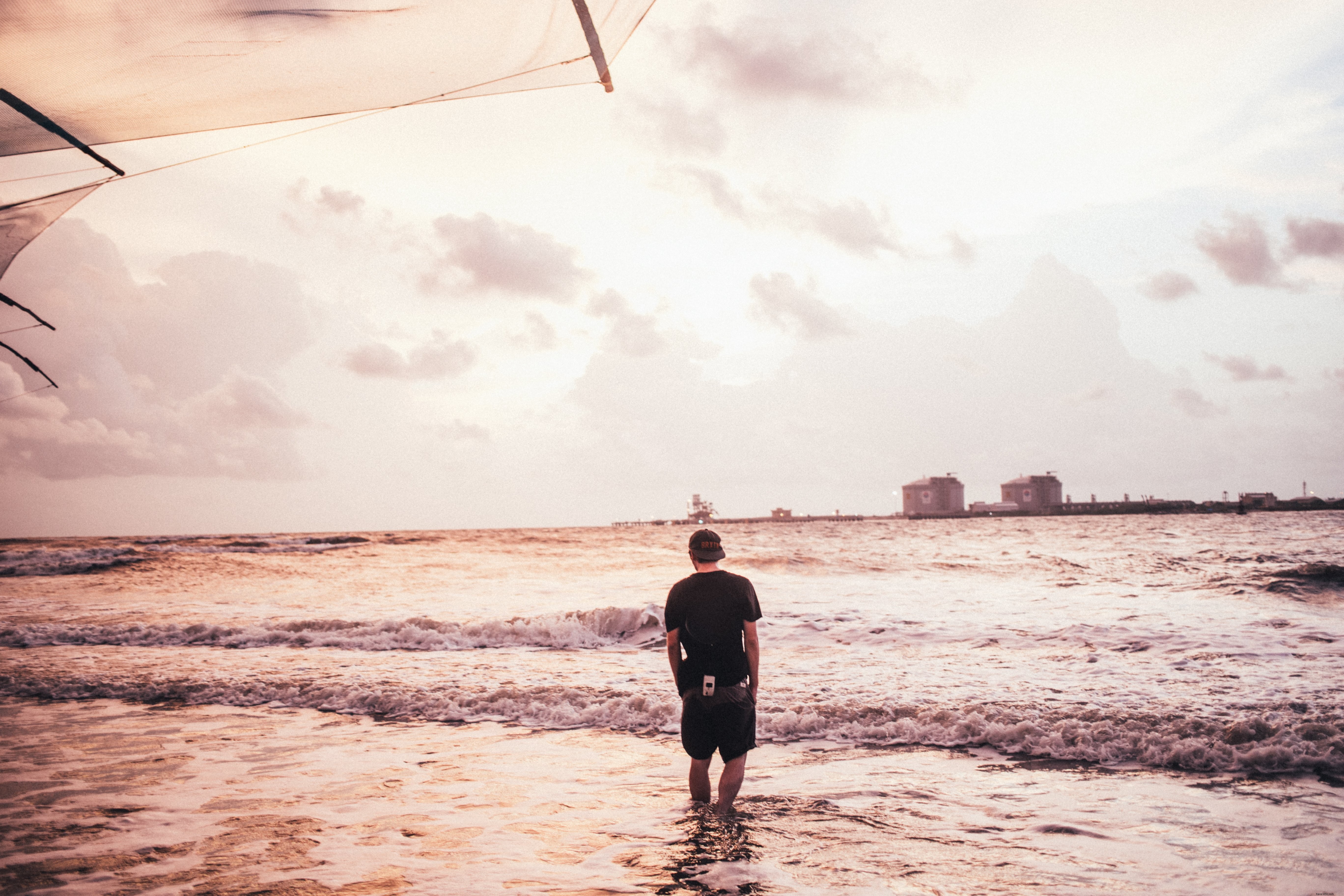 Stunning Photo: Man Bravely Wading Through Crashing Ocean Waves