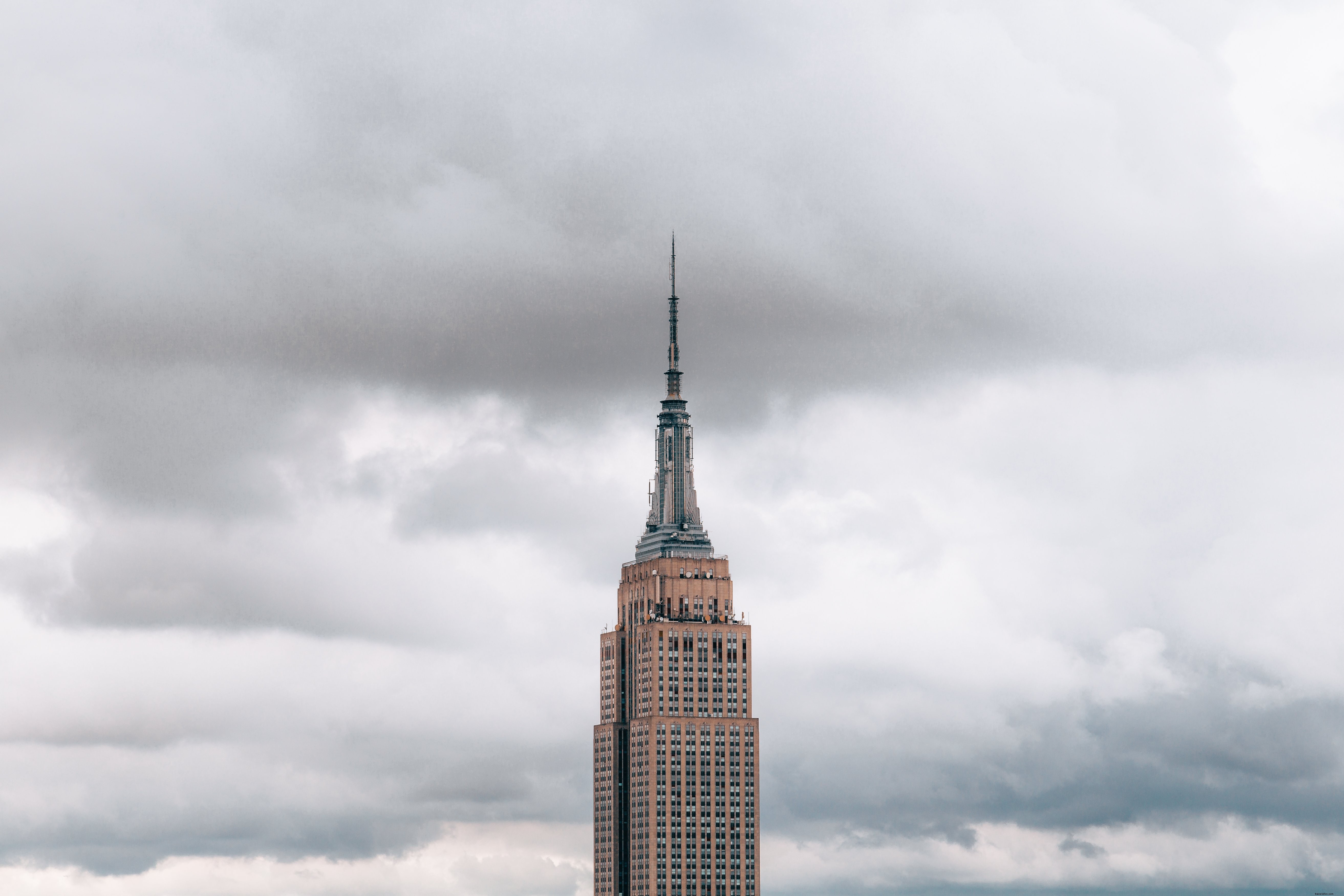 Stunning Empire State Building Summit: Dramatic Cloudy Sky View