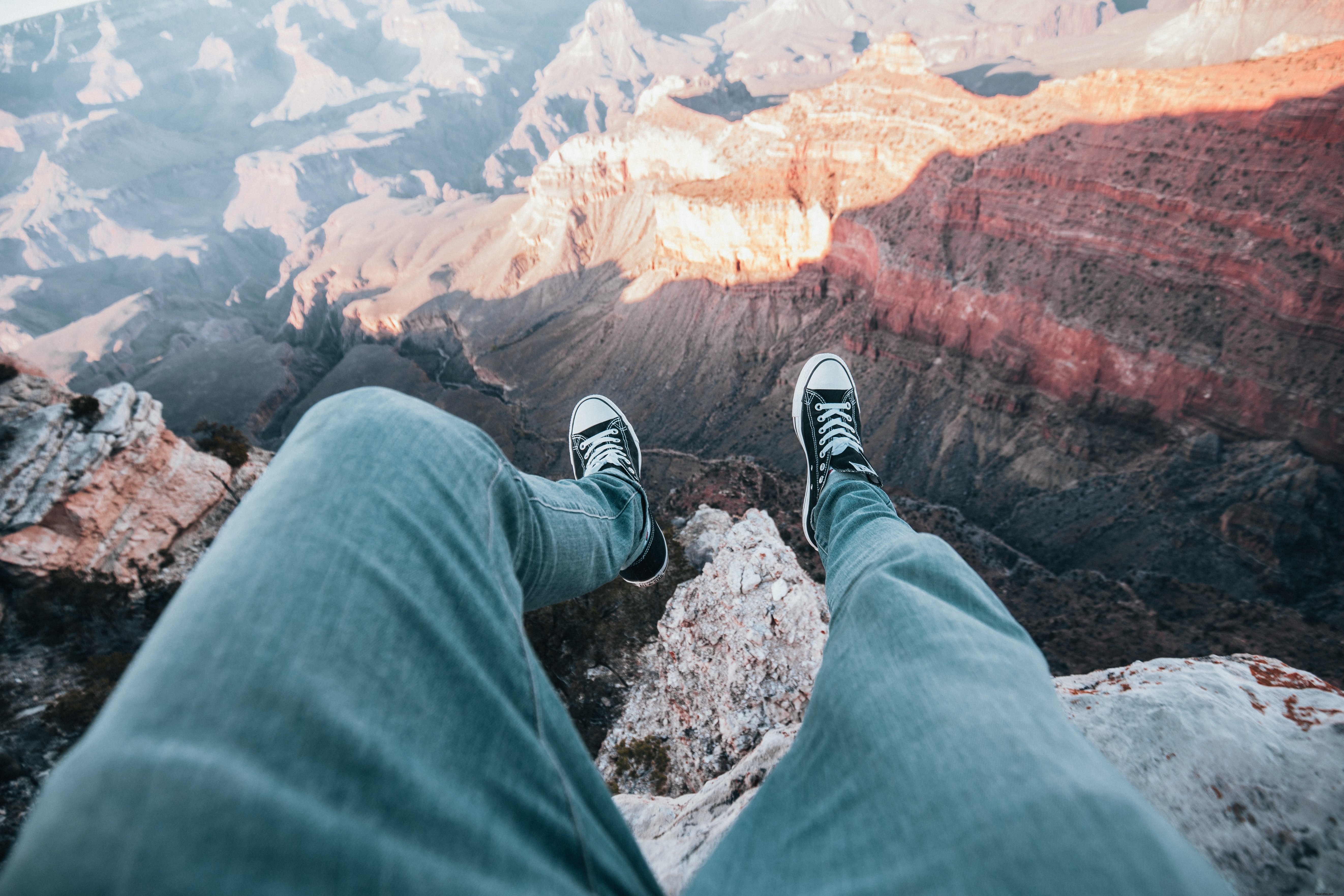 Thrilling Photo: Adventurer s Legs Dangling Over Canyon Edge