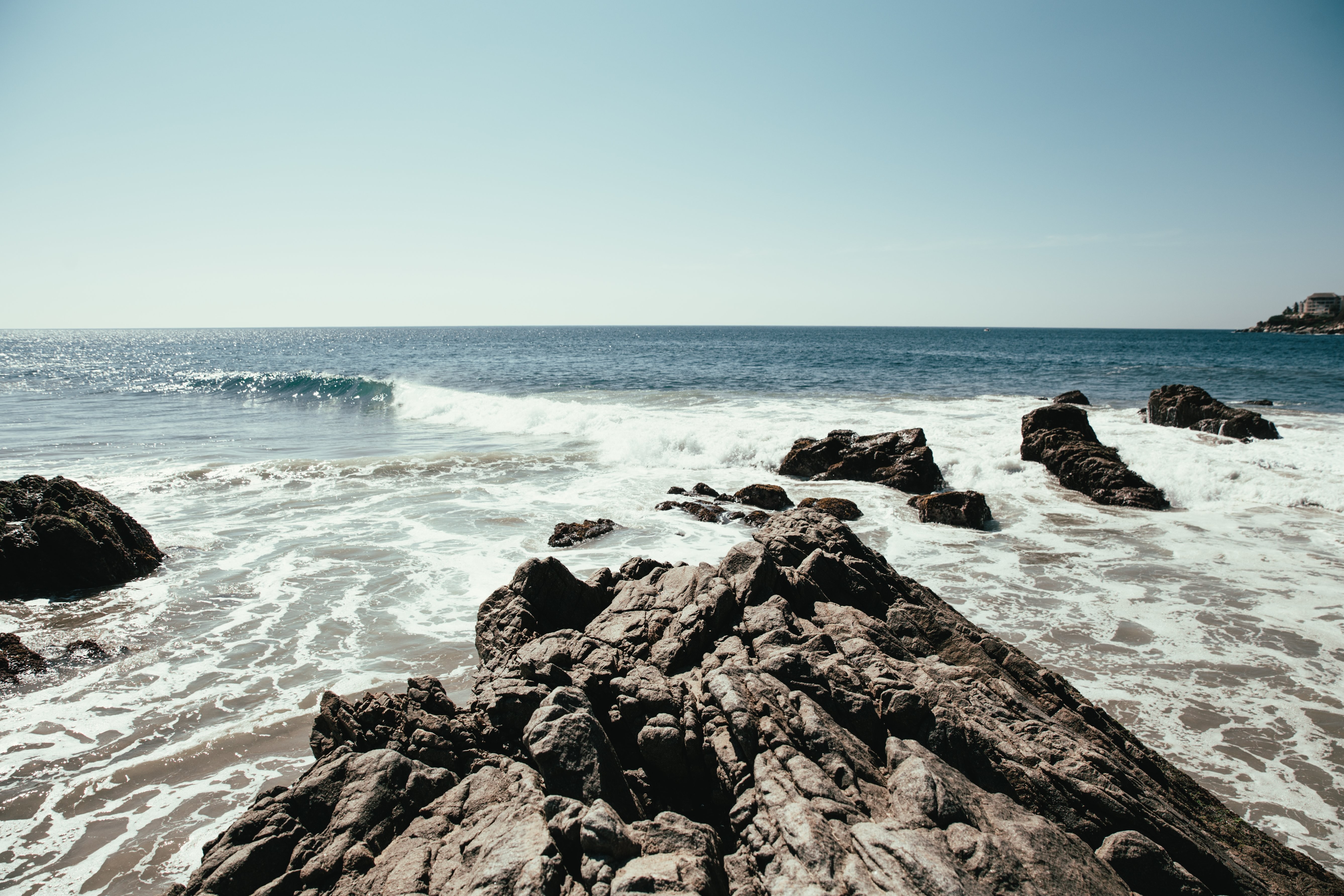 Stunning Rock Ledge Plunging into the Ocean – Breathtaking Photo