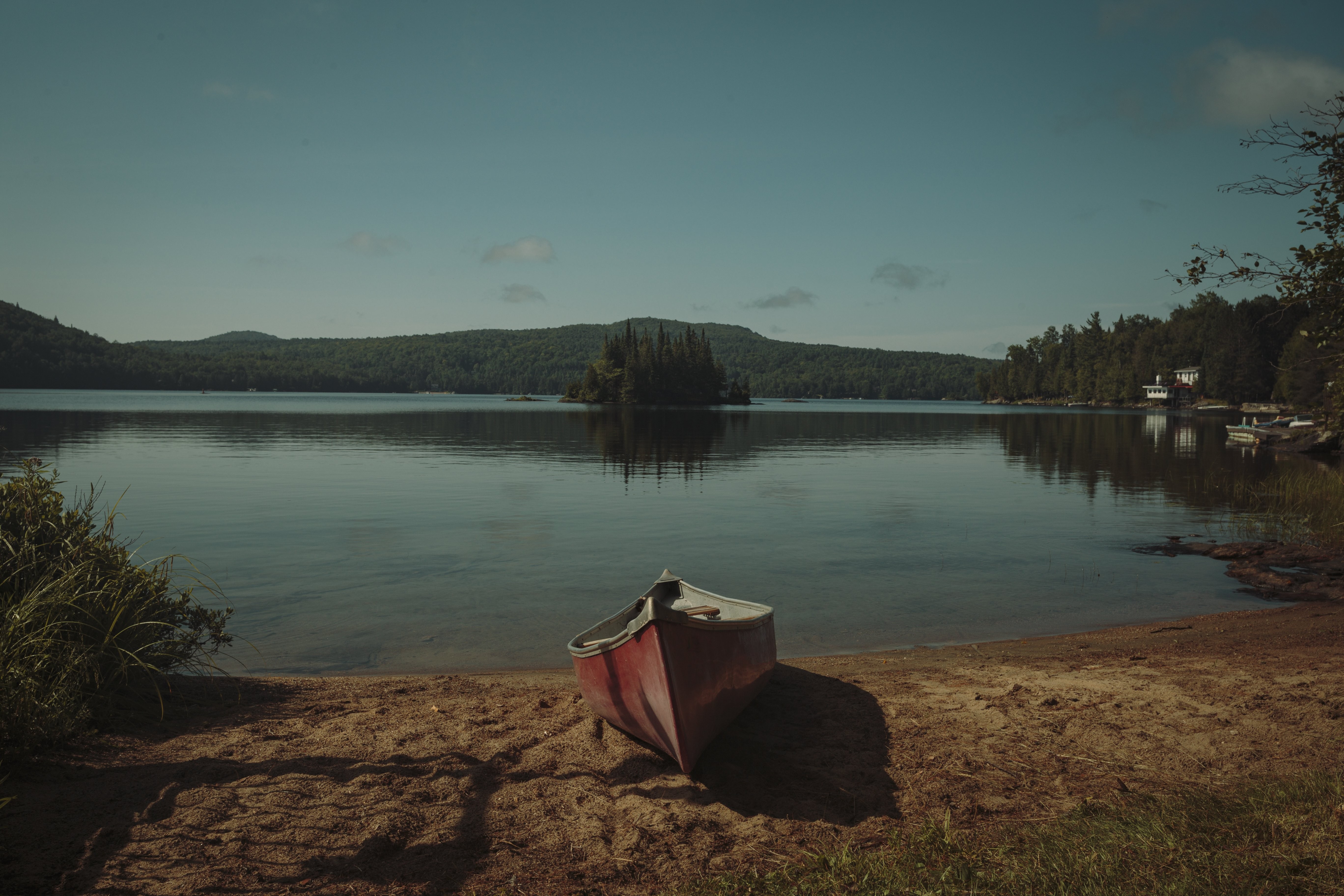 Serene Canoe Resting on a Secluded Small Beach – Stunning Photography