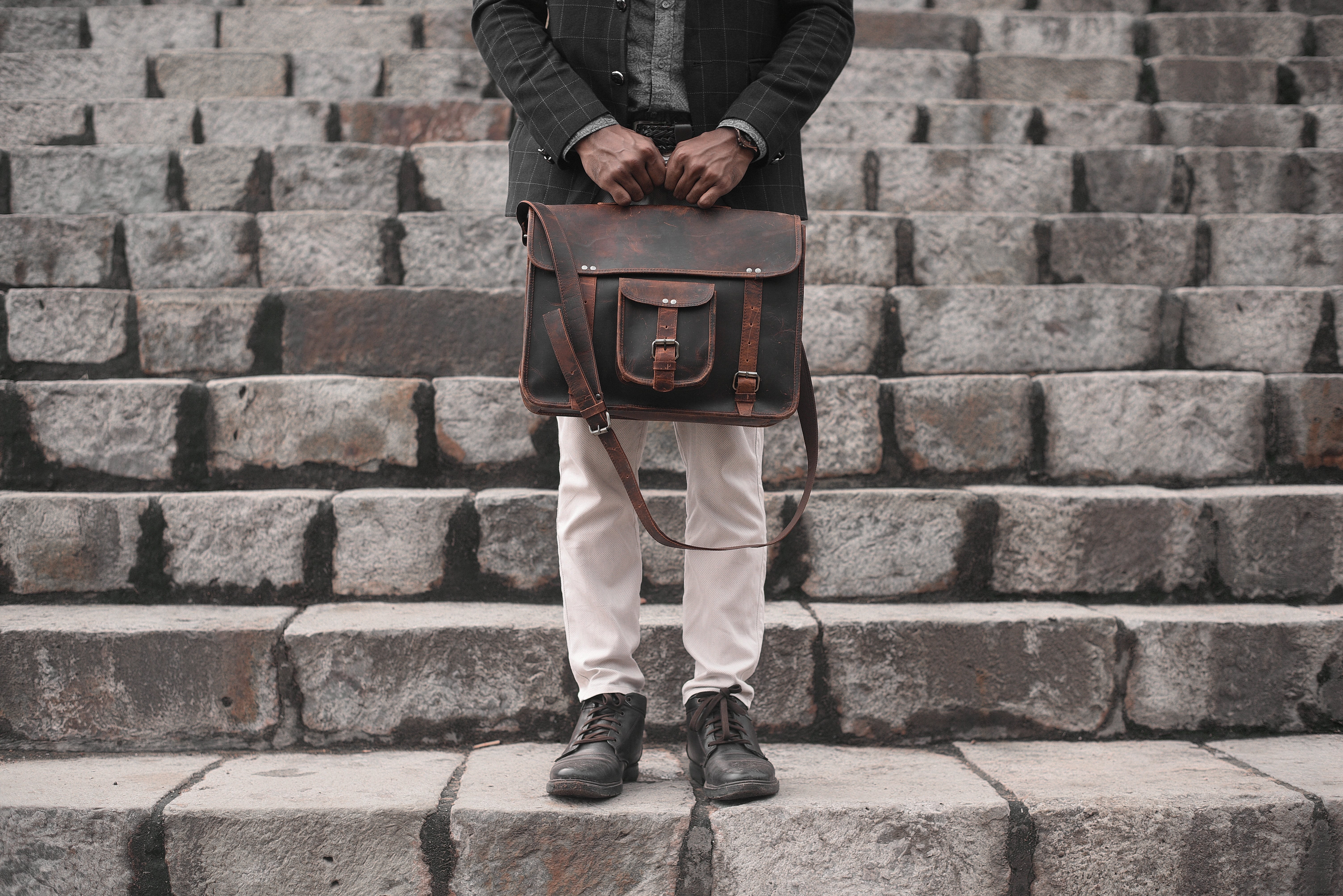 Stylish Man Holding Leather Bag on Urban Stairs – Professional Photo
