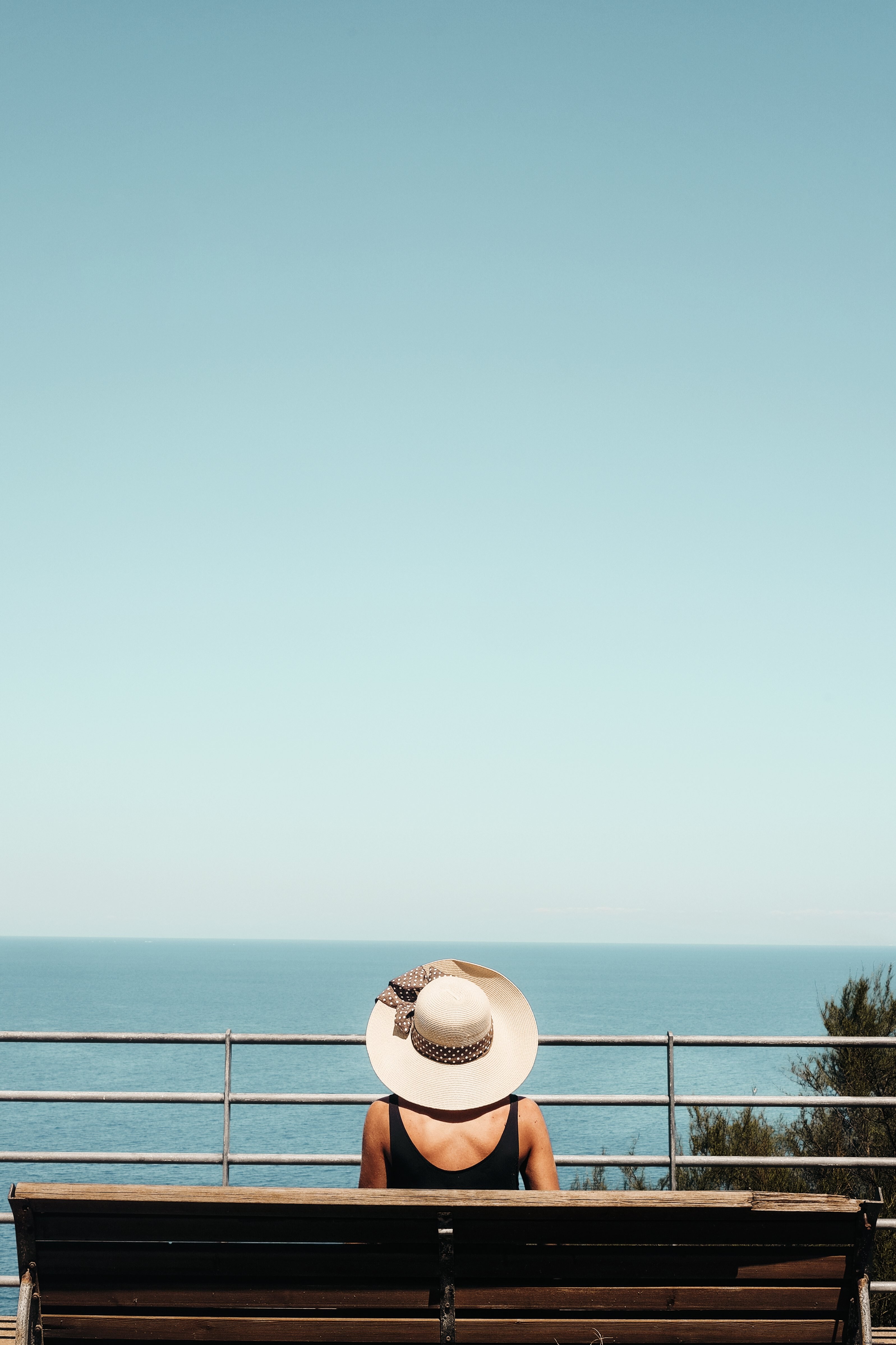Serene Solitude: Person on Bench Gazing at the Ocean Horizon