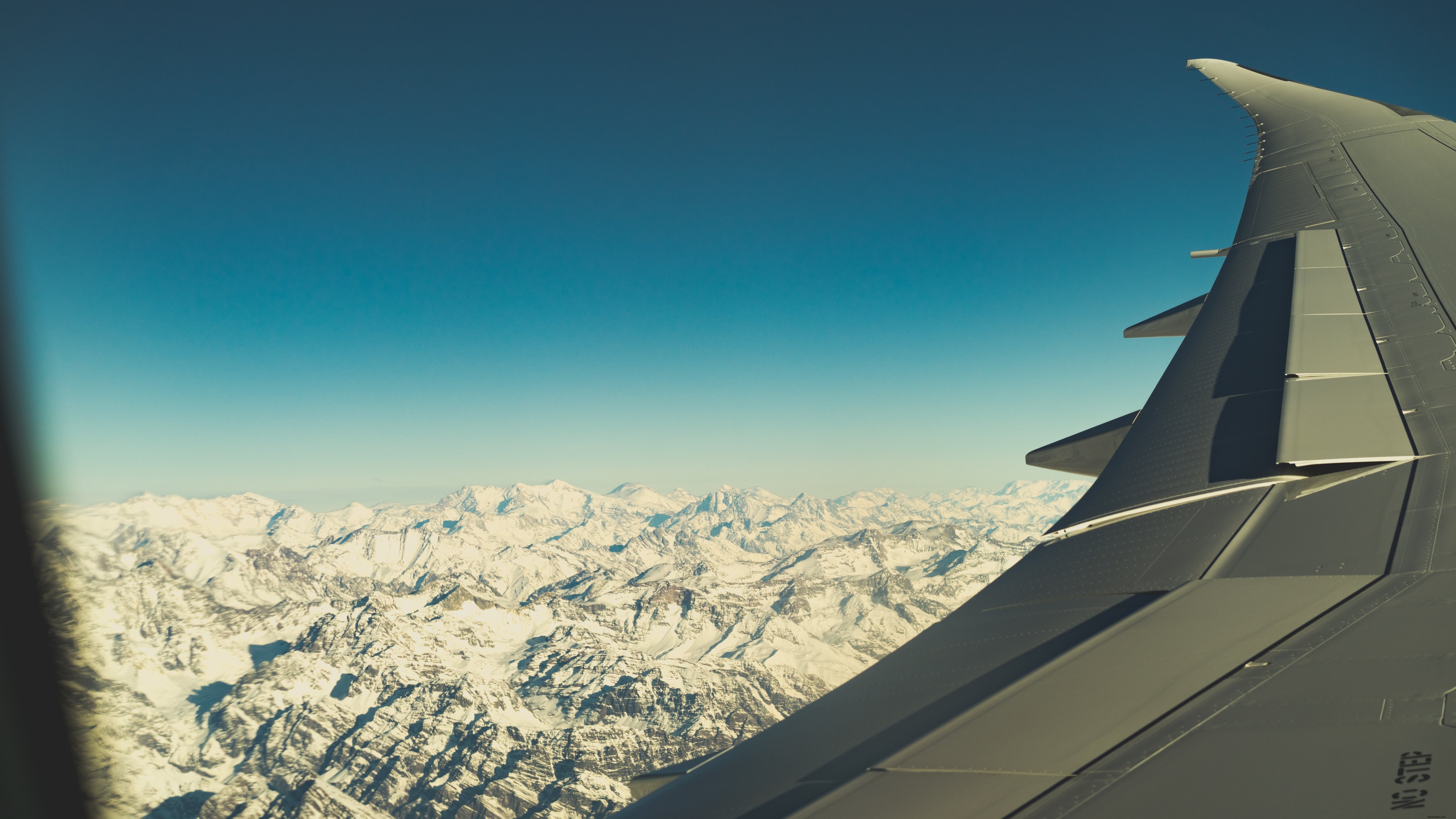 Breathtaking Snowy Peaks: Stunning Aerial View from Aircraft Window