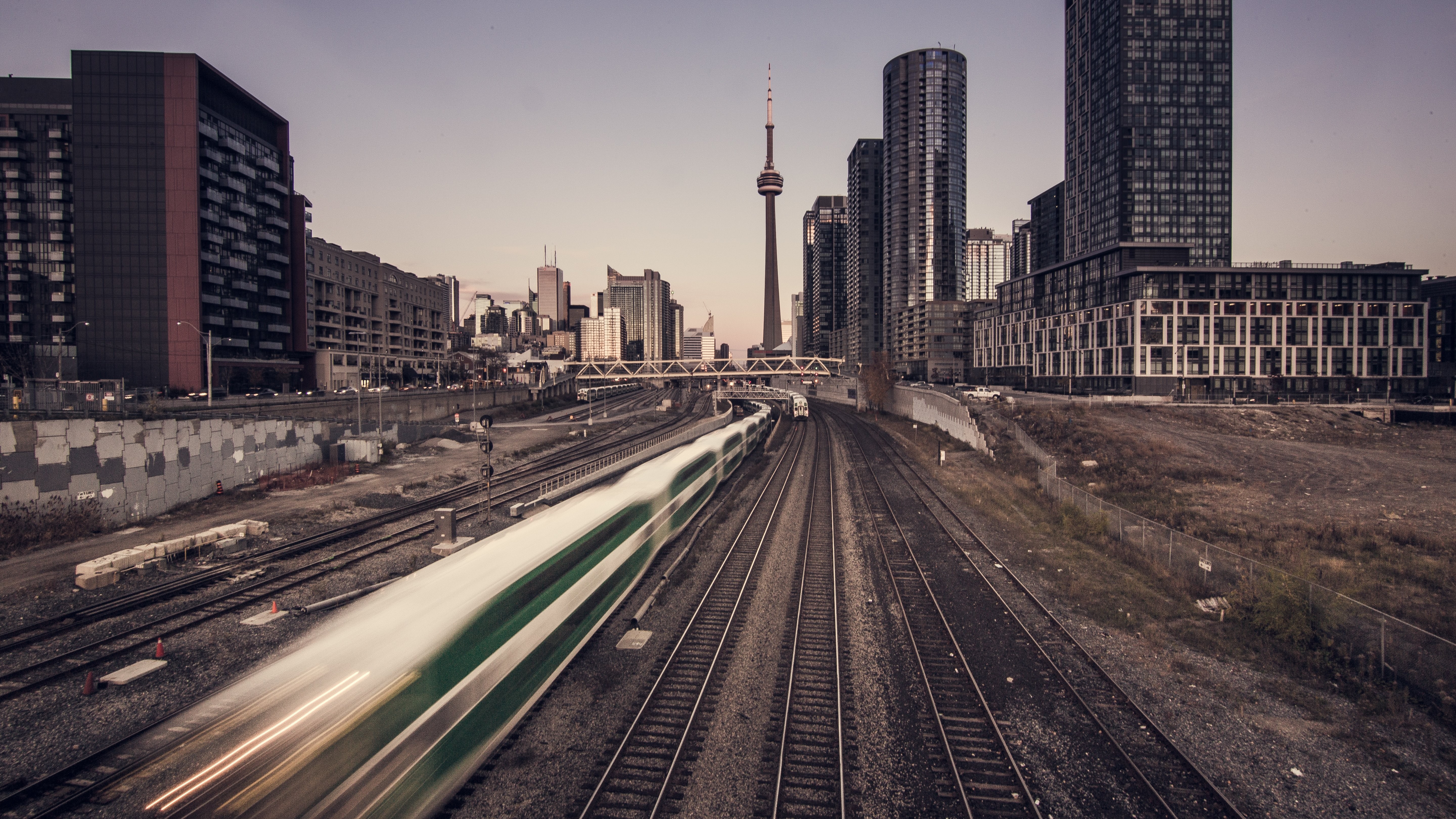 Stunning Photo: Commuter Train Speeds Through Bustling City Streets