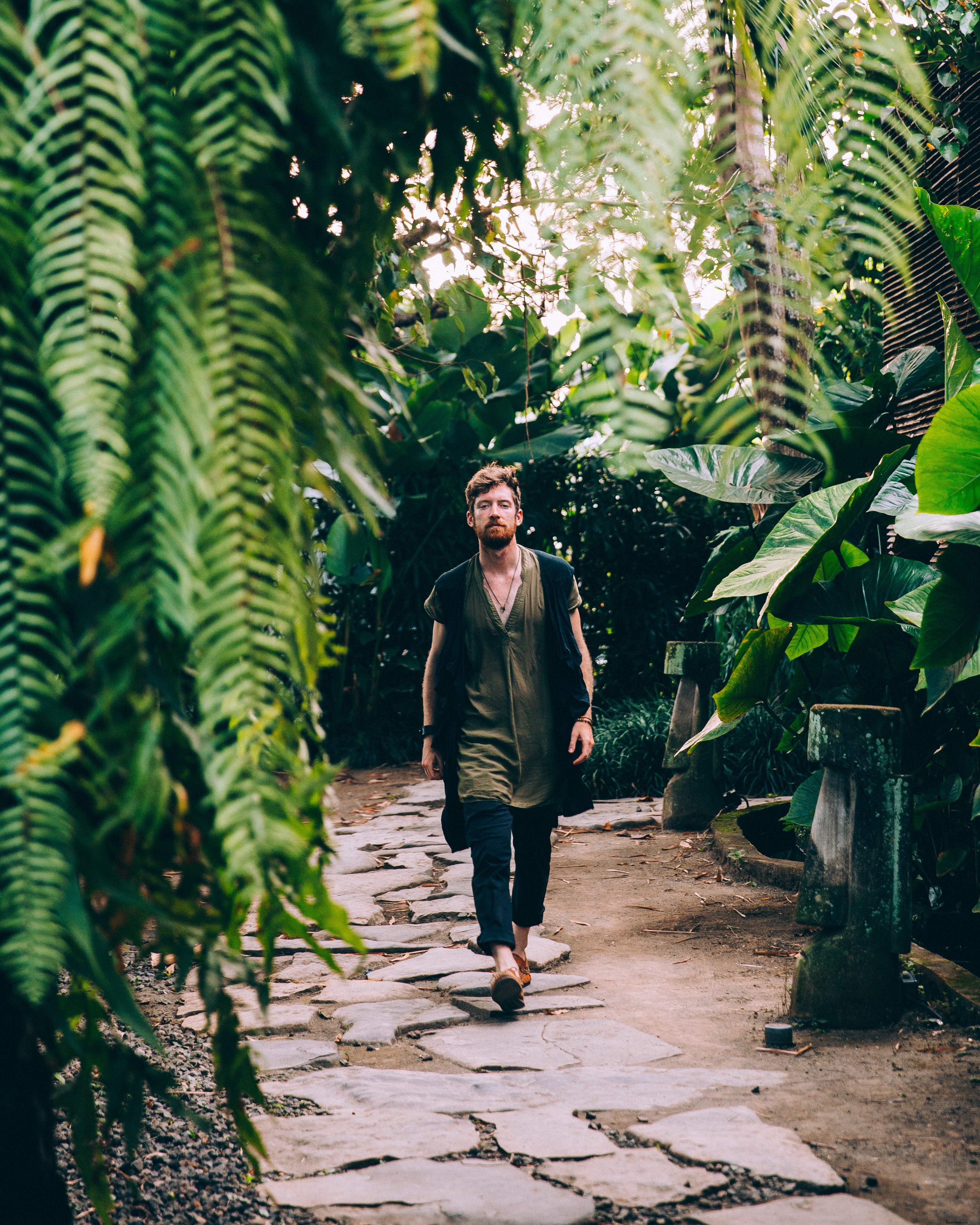 Man in Sandals Trekking Through Lush Fern Path – Stunning Nature Photo