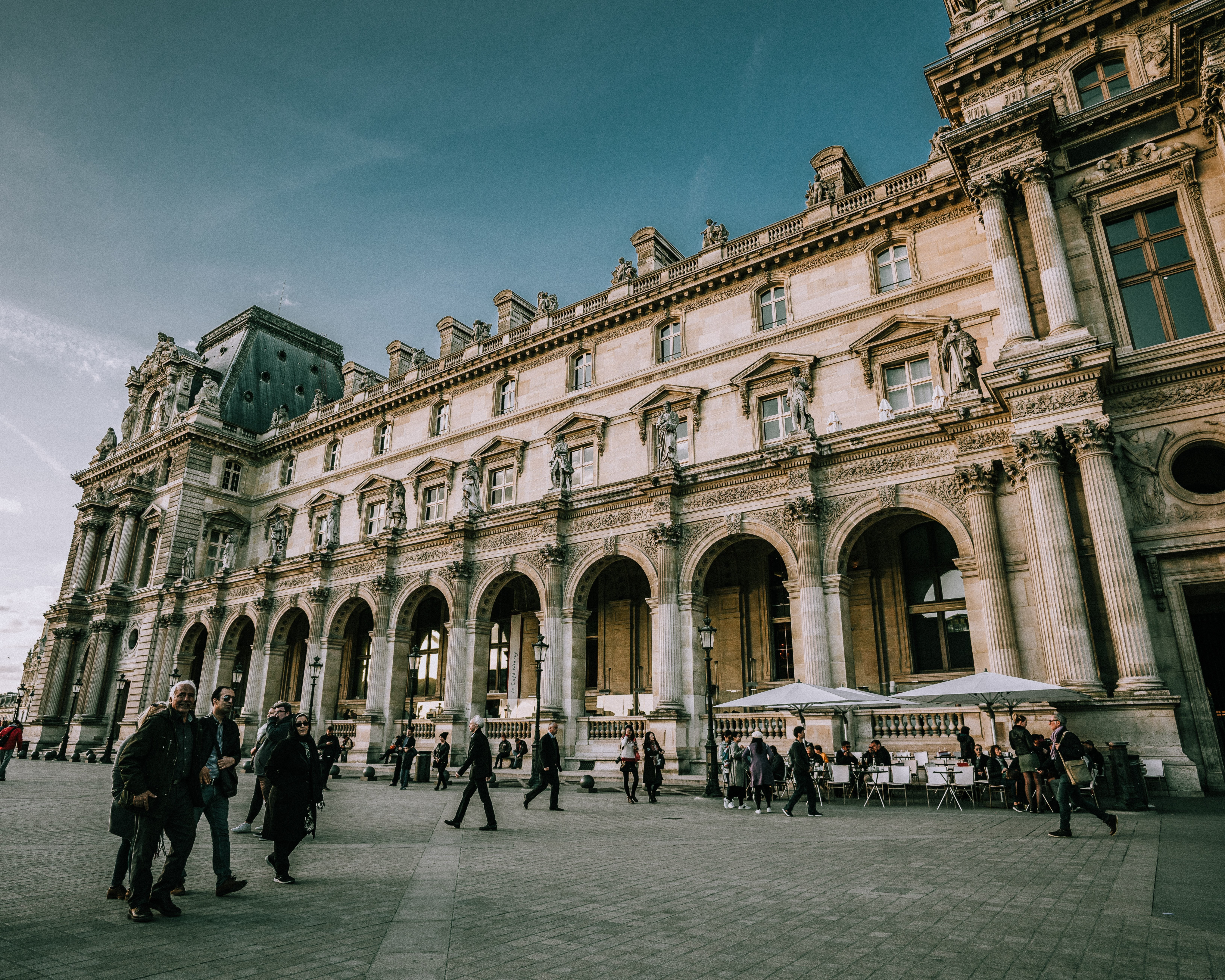 Stunning Photo of Tourists Crowding Outside the Iconic Louvre Museum