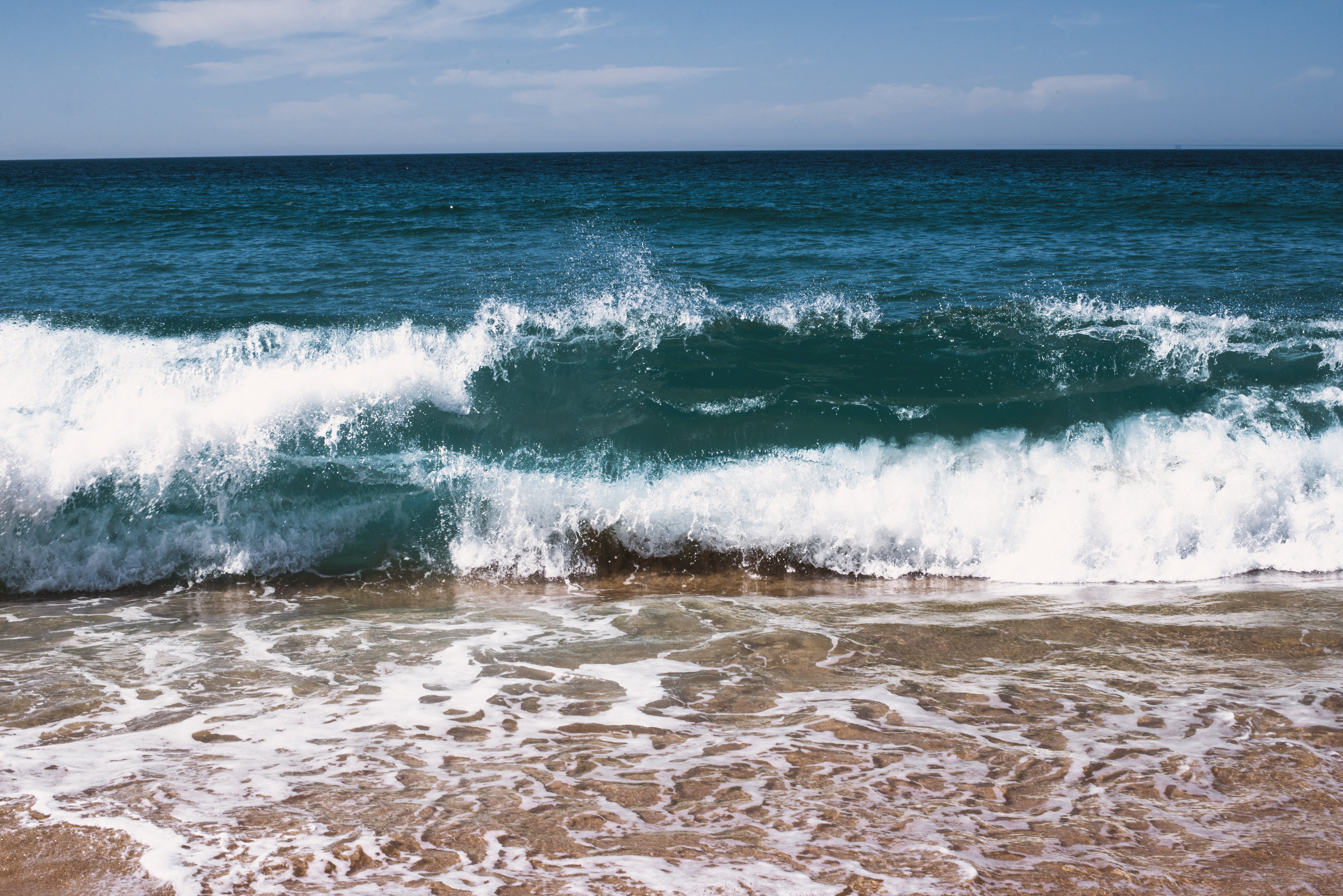 Stunning Photo of Deep Blue Waves Rolling onto the Shore