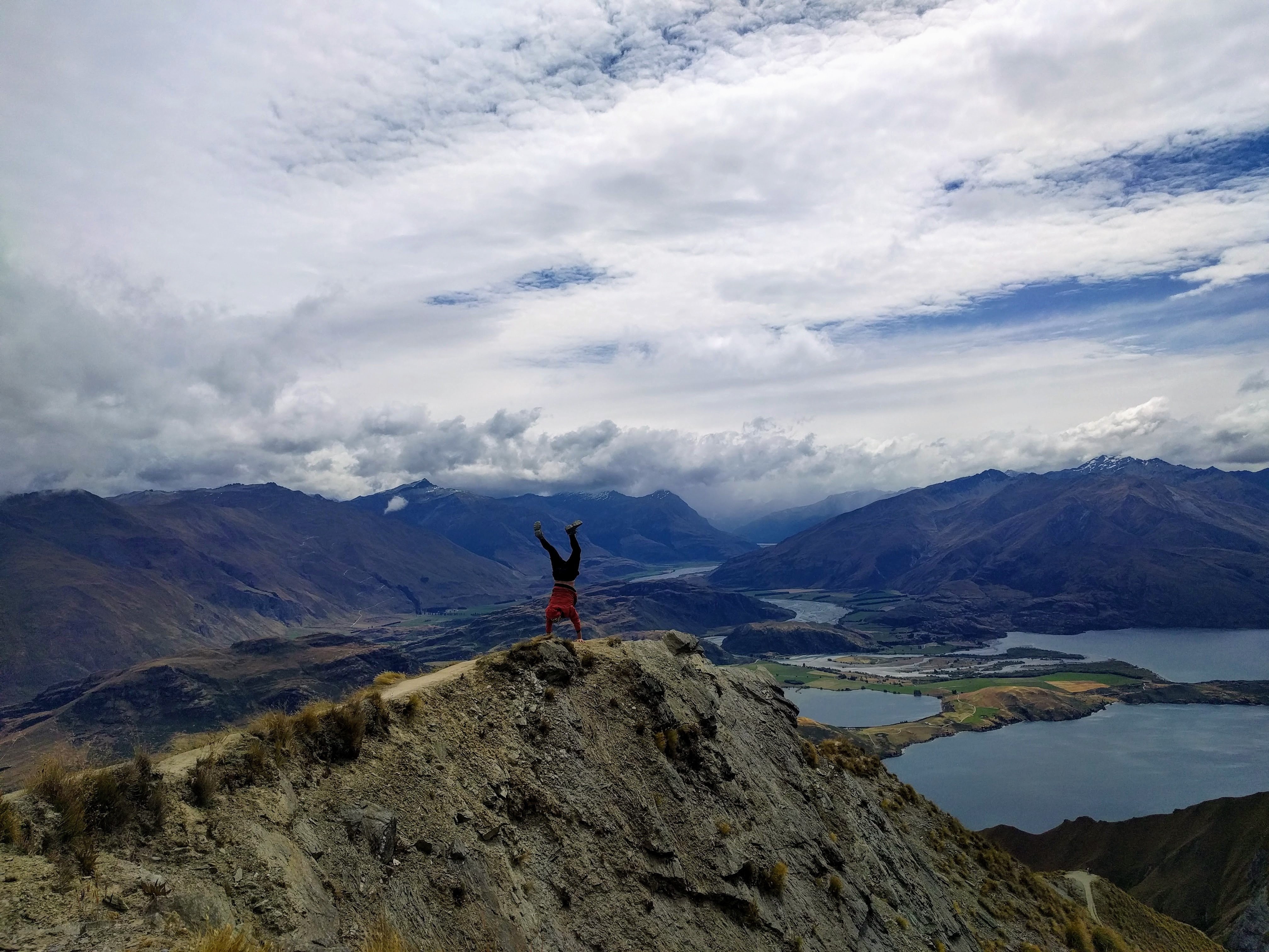 Daring Cartwheel on Mountain Edge: Thrilling Extreme Adventure Photo