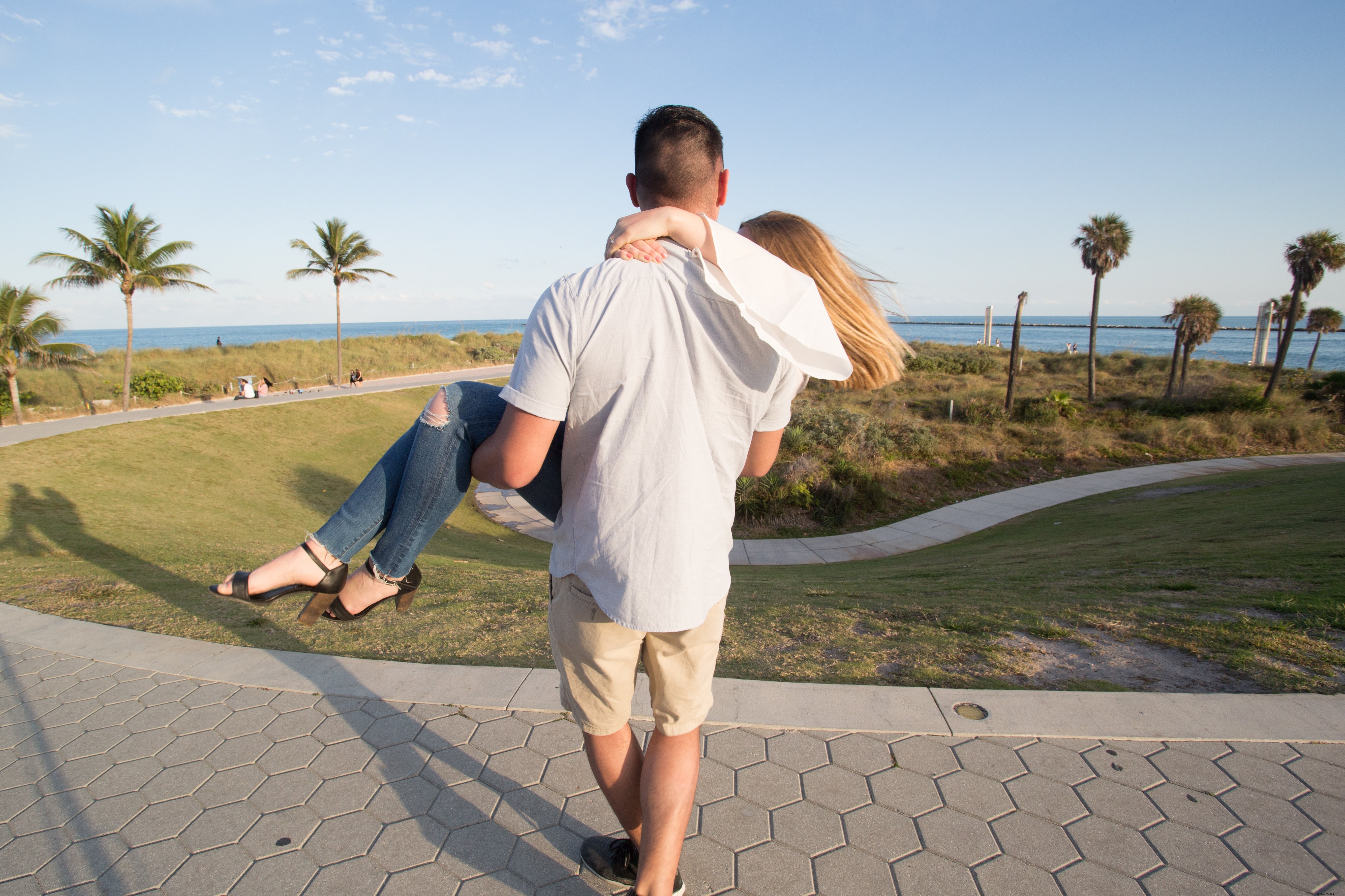 Heartwarming Park Photo: Man Carries Woman in Romantic Embrace