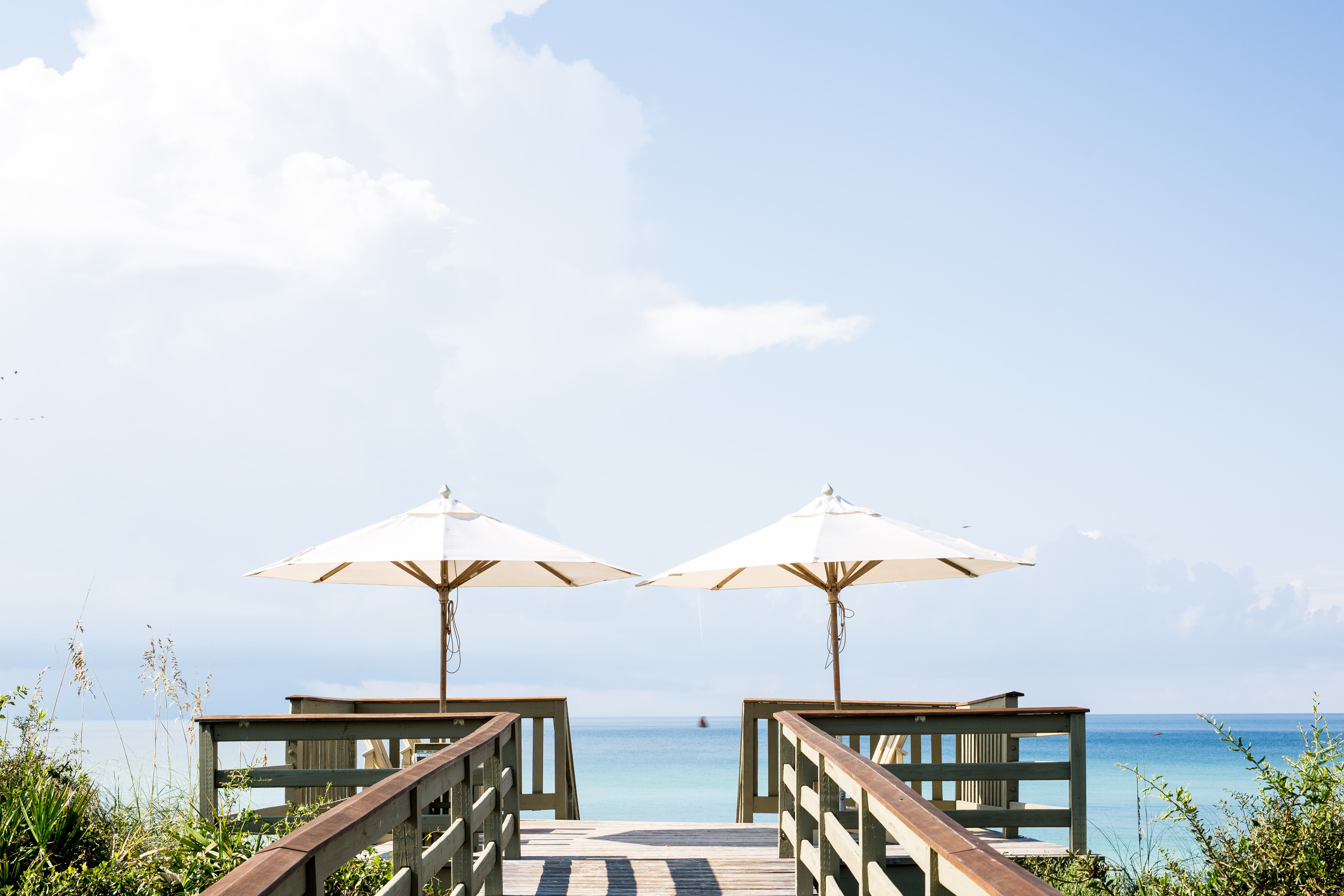 Stunning Photo: Two Parasols Side by Side on a Sunny Boardwalk