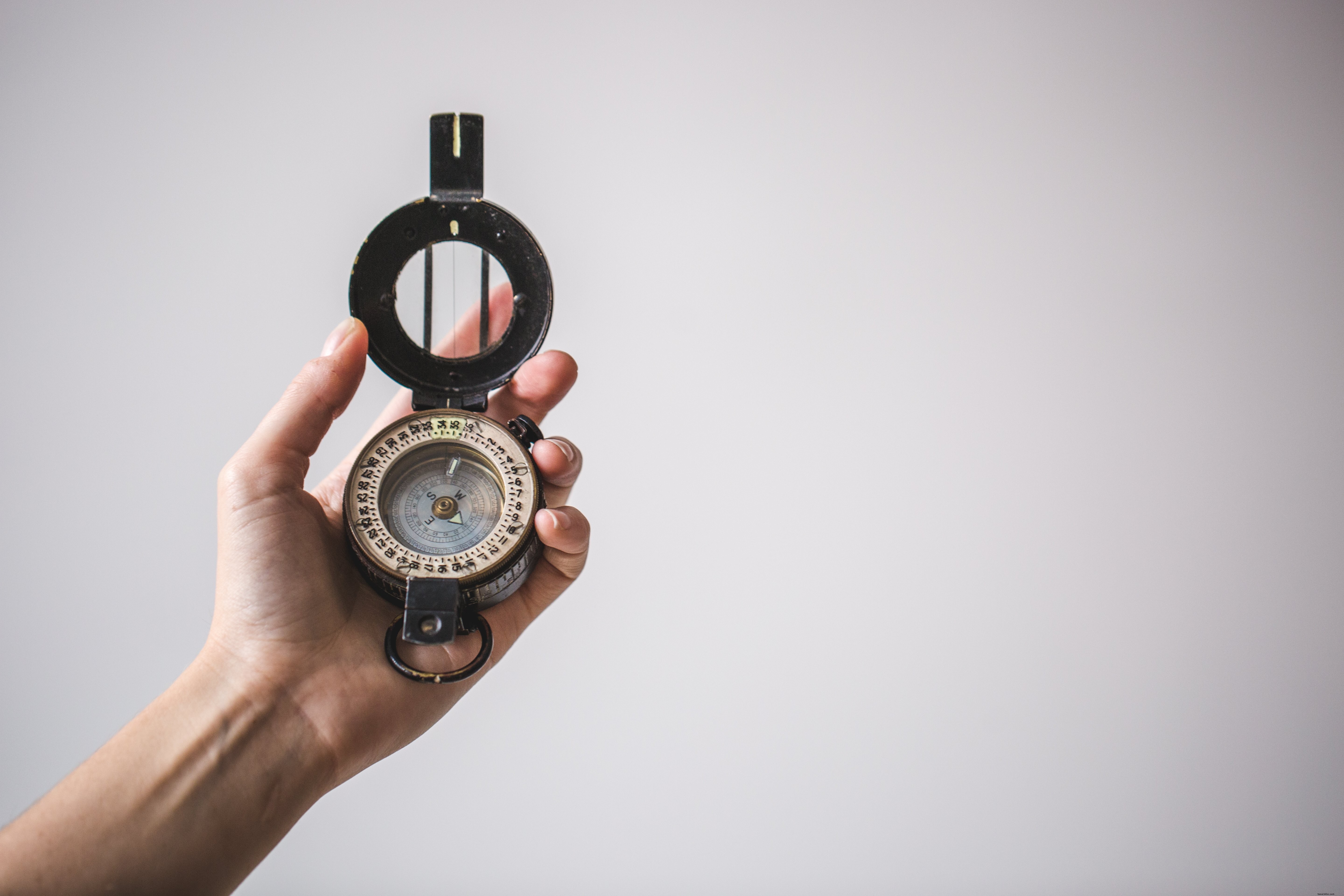 Hand Holding Compass Upward: Captivating Adventure Photography