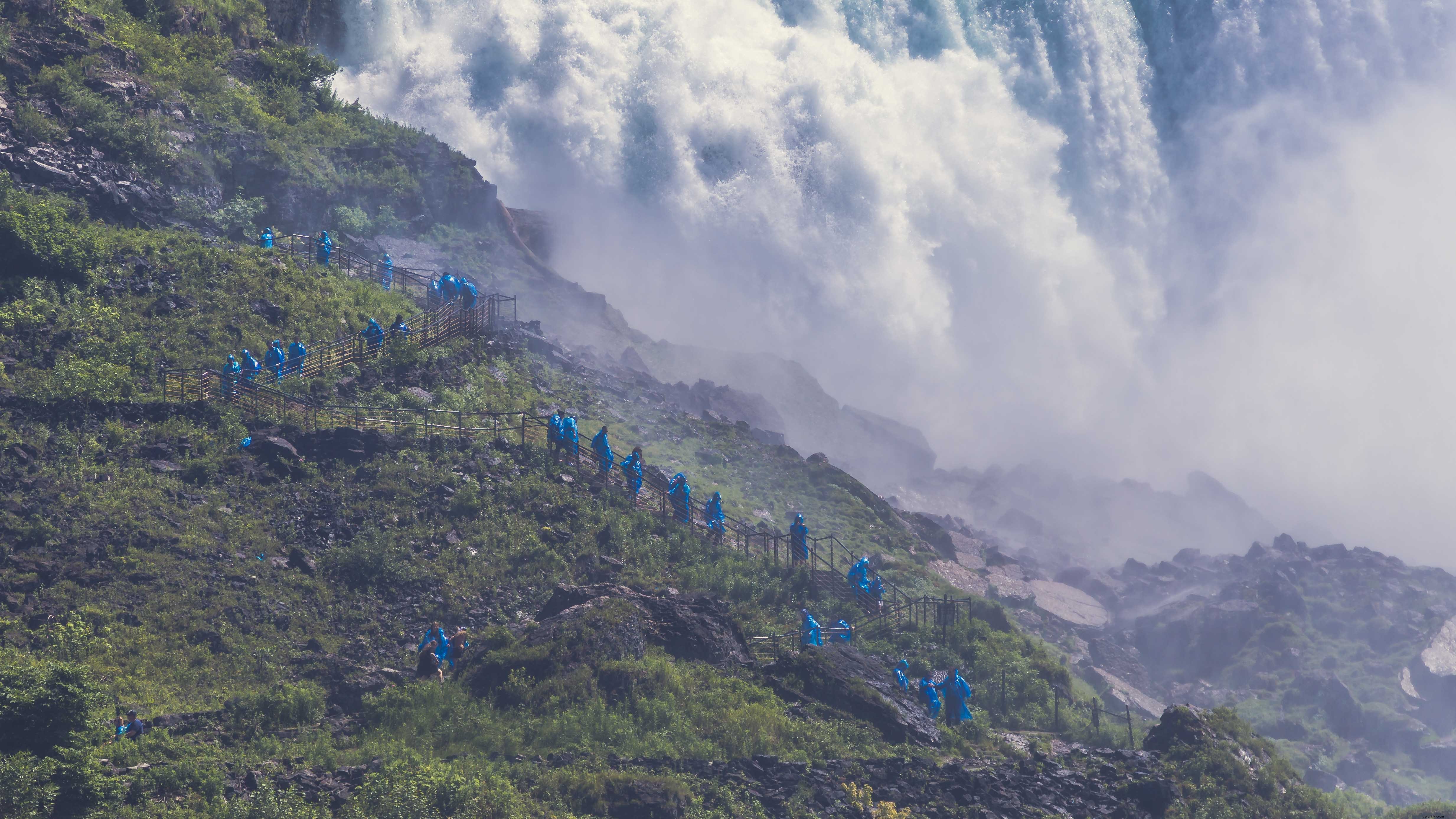 Stunning Photo of Adventurous Hikers Trekking Beside a Majestic Waterfall