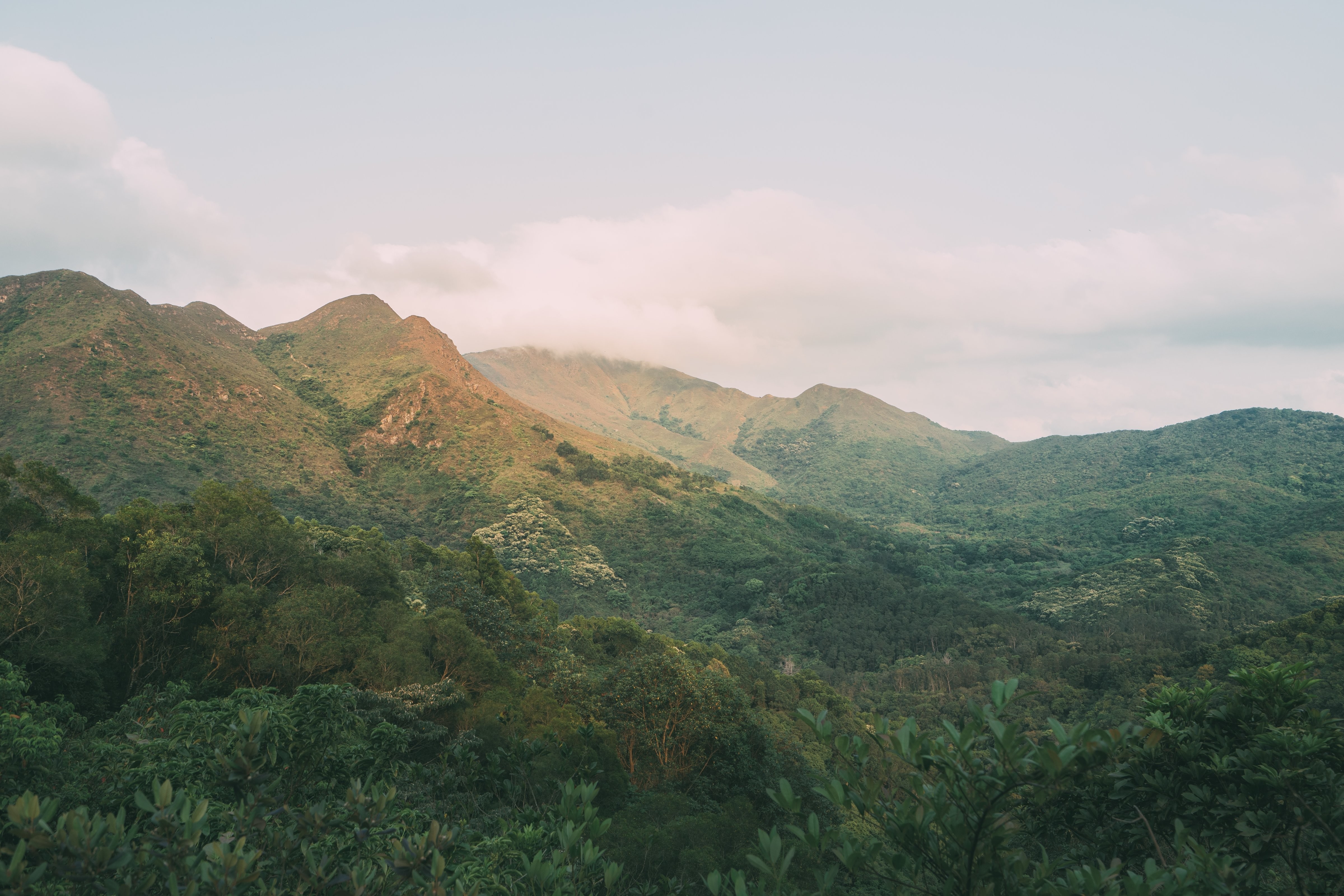 Breathtaking Clouds Rolling Over Lush Verdant Mountains – Stunning Landscape Photo