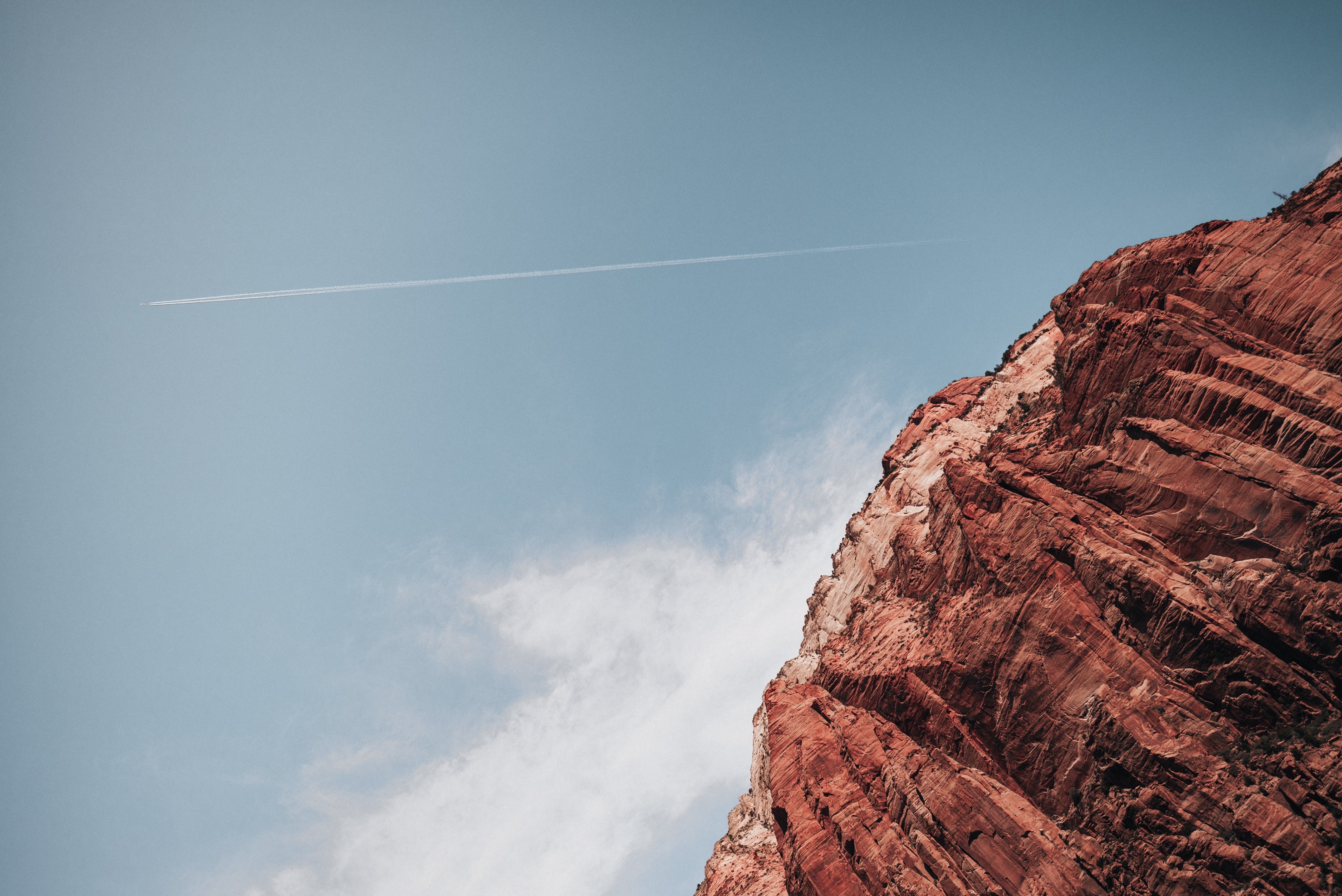 Breathtaking Jetstream Streaking Across Sky Over Majestic Canyon Photo