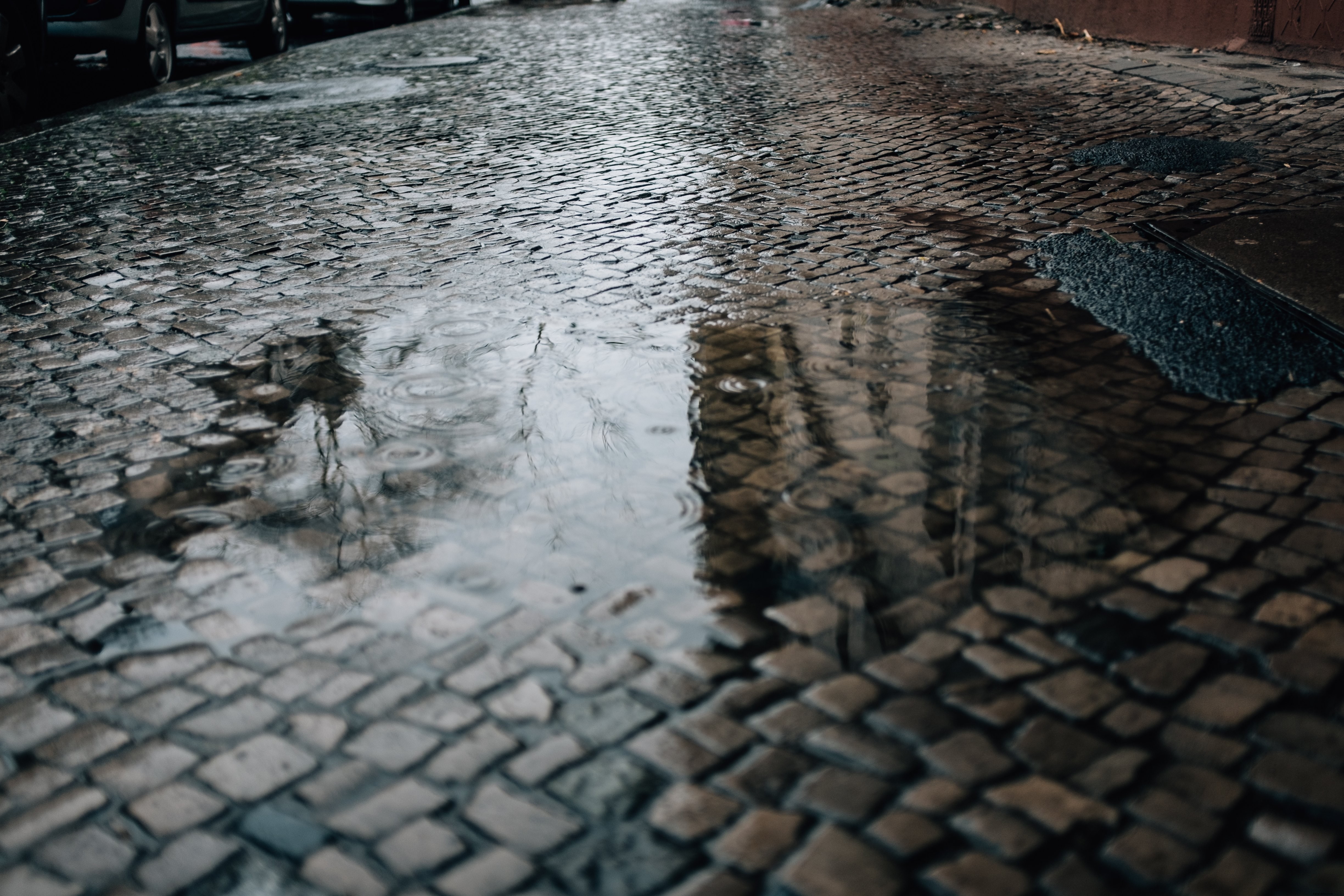 Captivating Puddle Reflection on Historic Cobblestone Street
