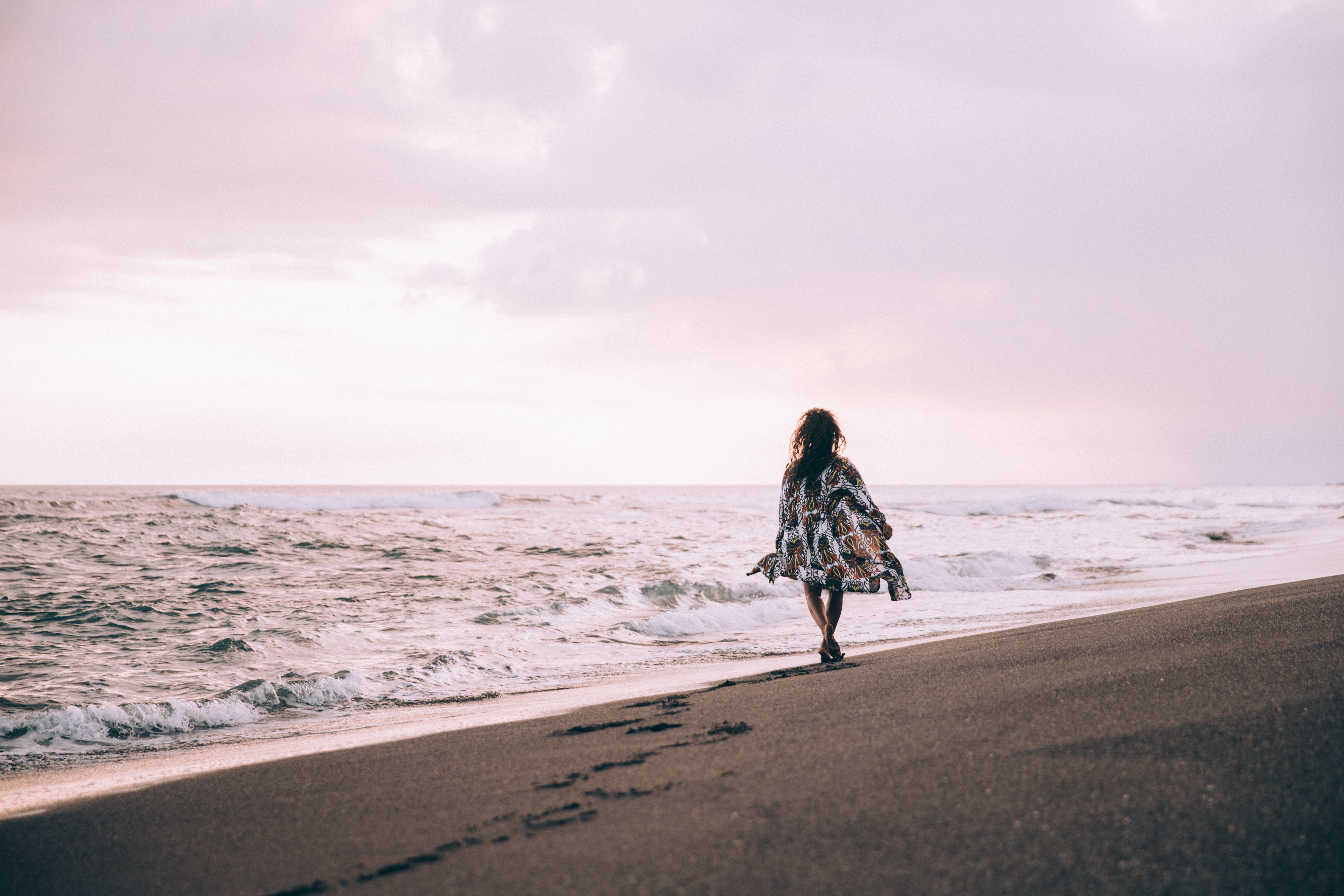 Elegant Tanned Woman in Flowing Beach Robe Strolling Along the Sunny Shore – Stunning Photo