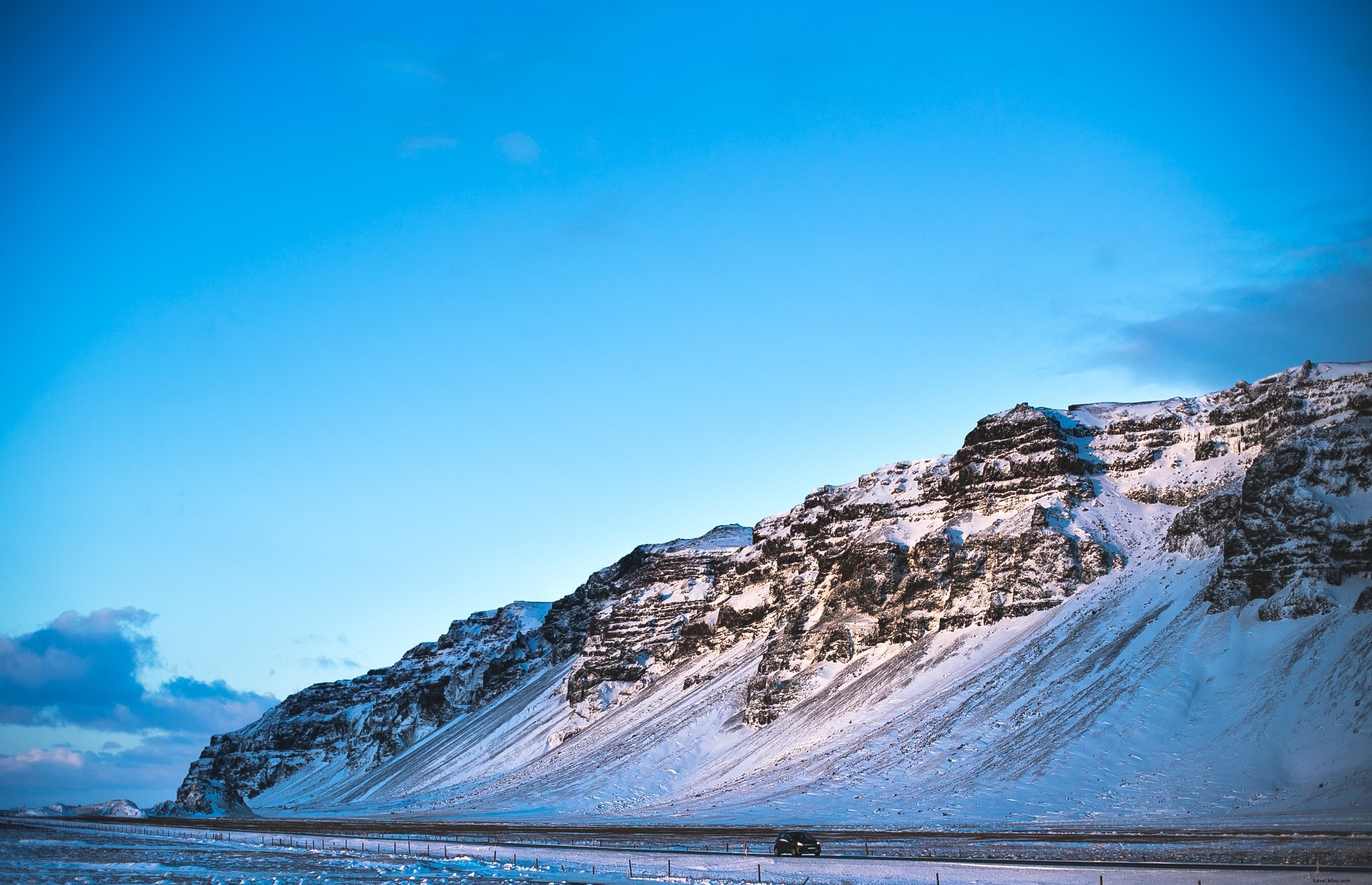 Stunning Photo: Compact Car Cruising Past Iceland s Majestic Hills