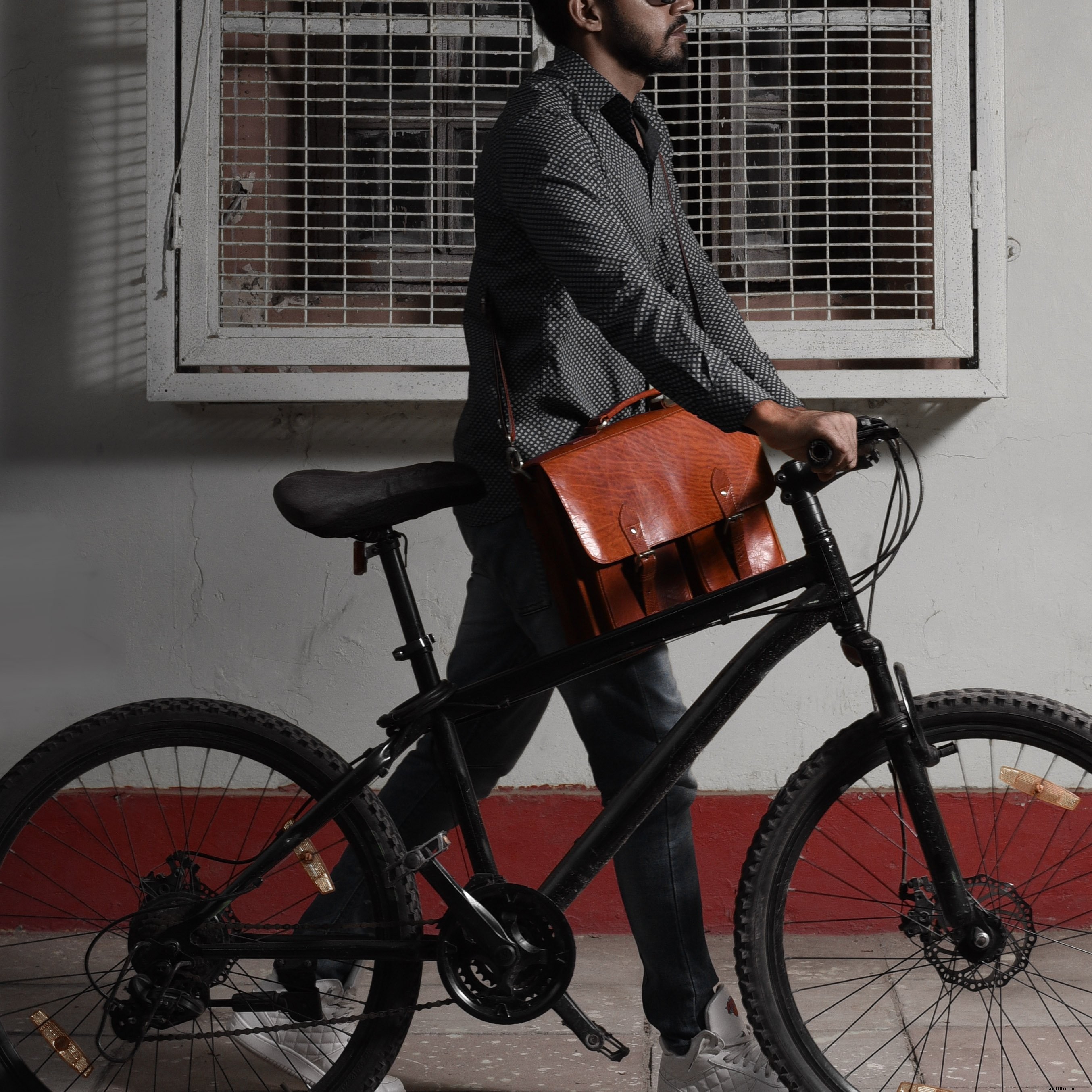 Stylish Cyclist with Premium Leather Messenger Bag – High-Quality Photo