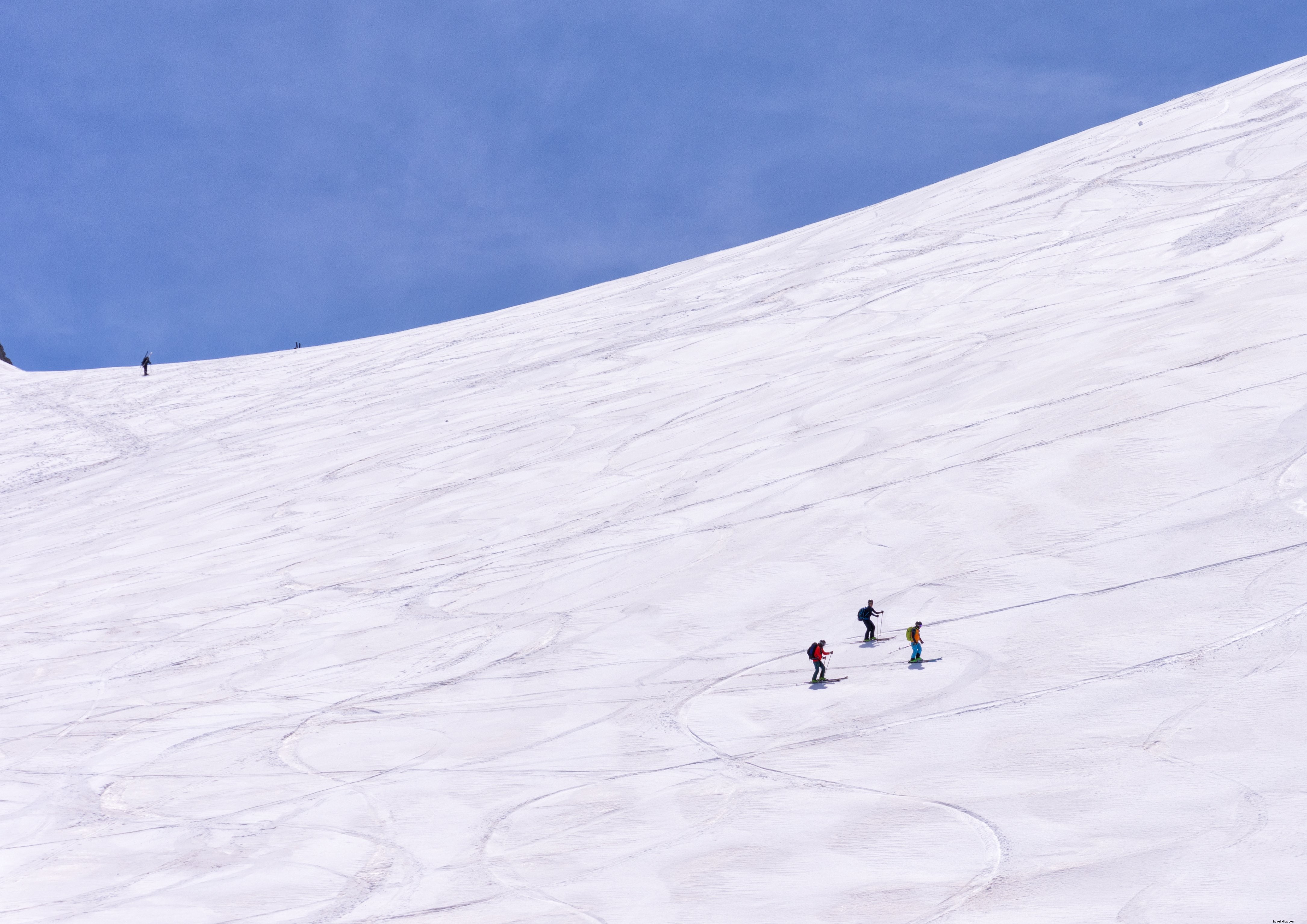 Stunning Photo of Skiers Traversing a Pristine Snowy Slope