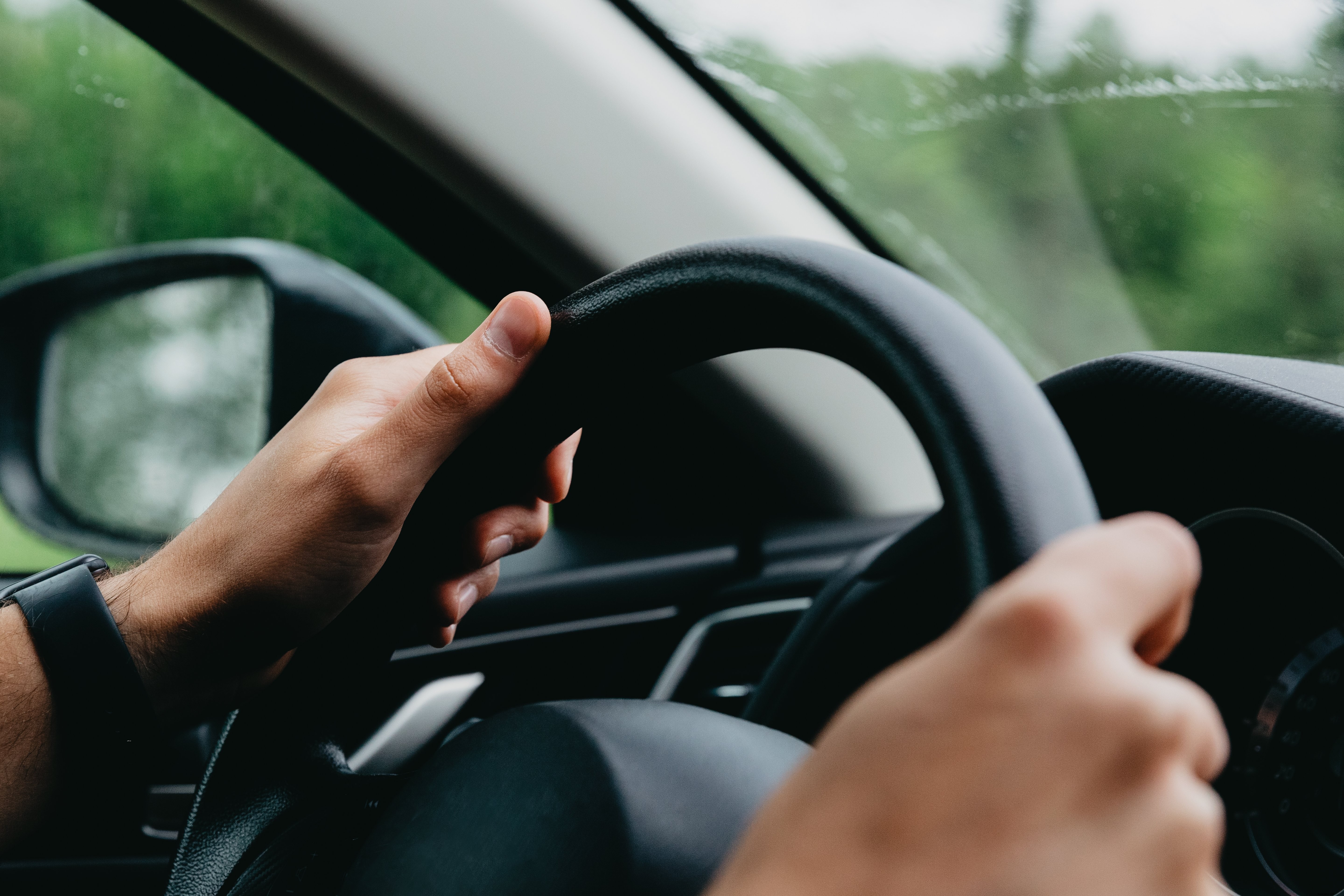 Close-Up: Hands Firmly Gripping Steering Wheel – High-Quality Stock Photo