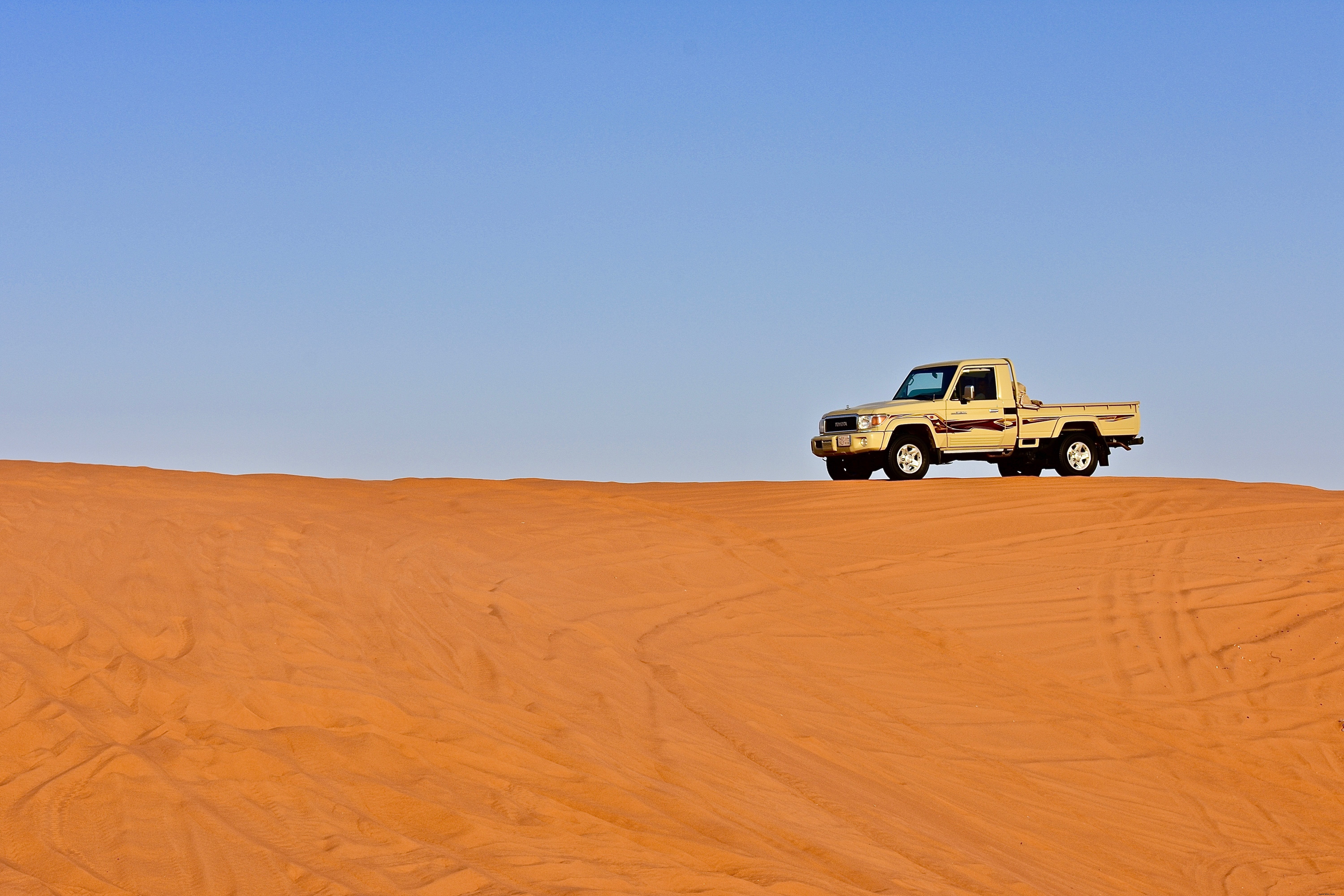 Stunning Pickup Truck on Golden Desert Dunes Under Vibrant Blue Sky – Epic Photo