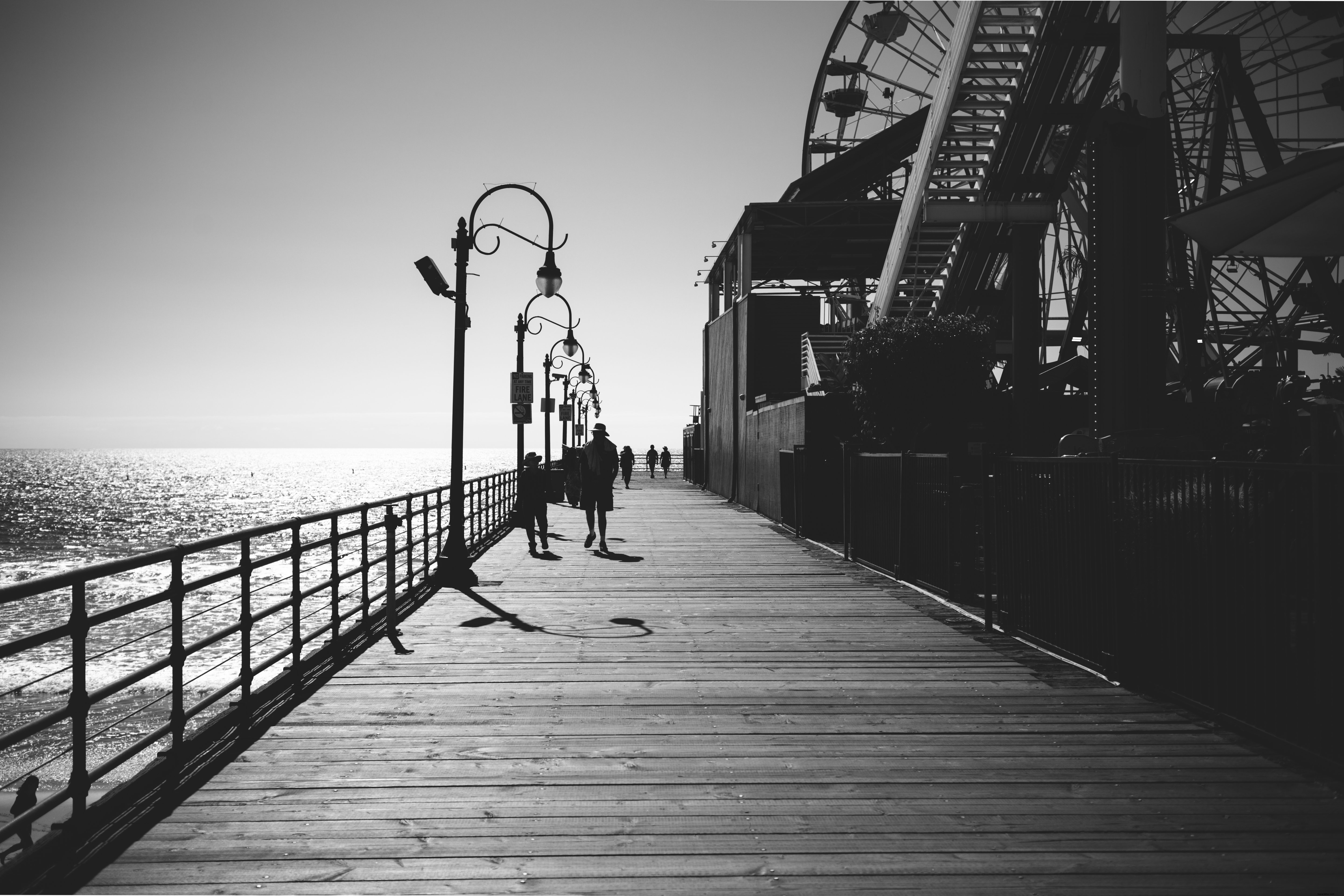 Stunning Black & White Photo: Solitary Stroll Along the Boardwalk