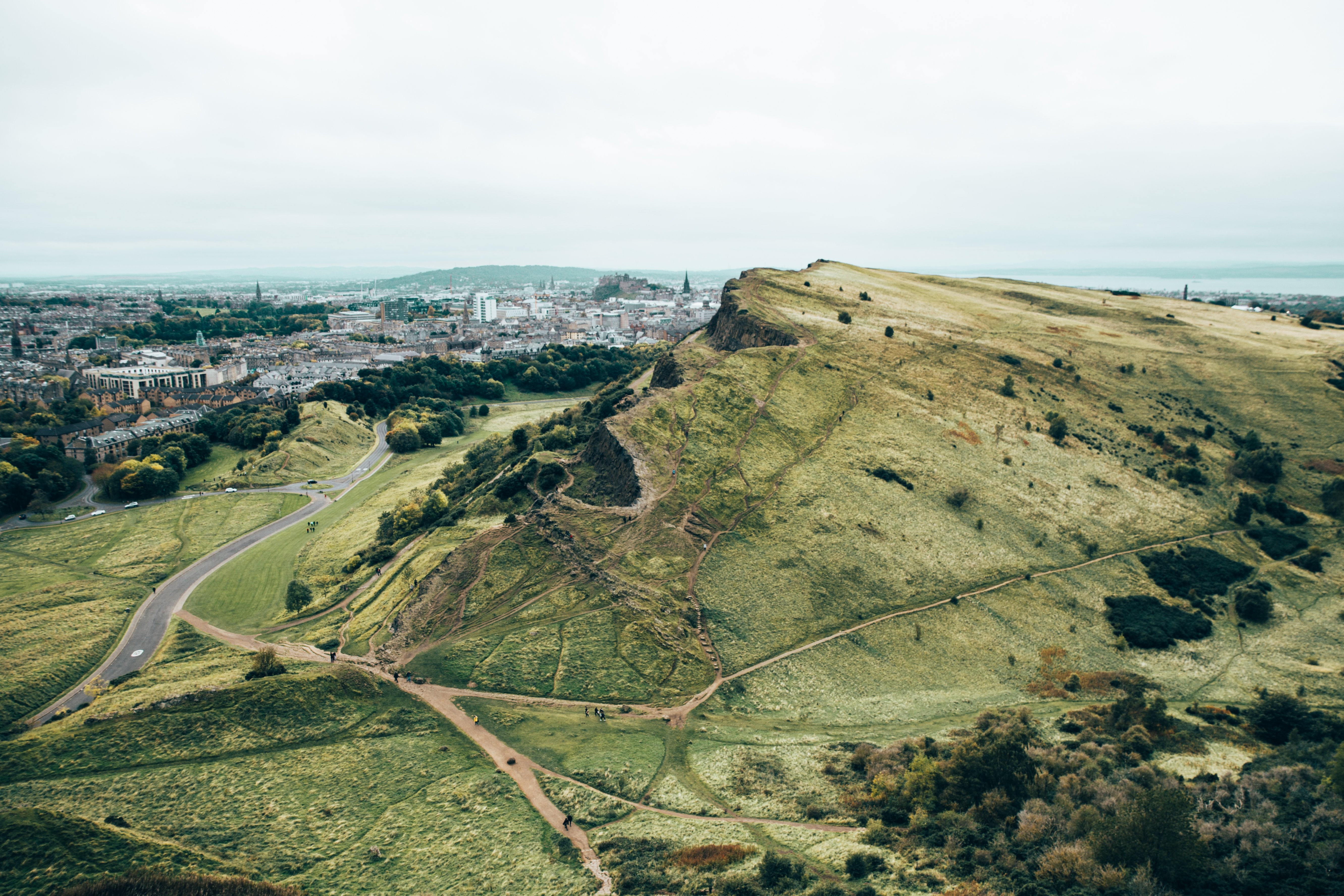 Majestic Green Hills Overlooking a Thriving Growing City – Stunning Photo