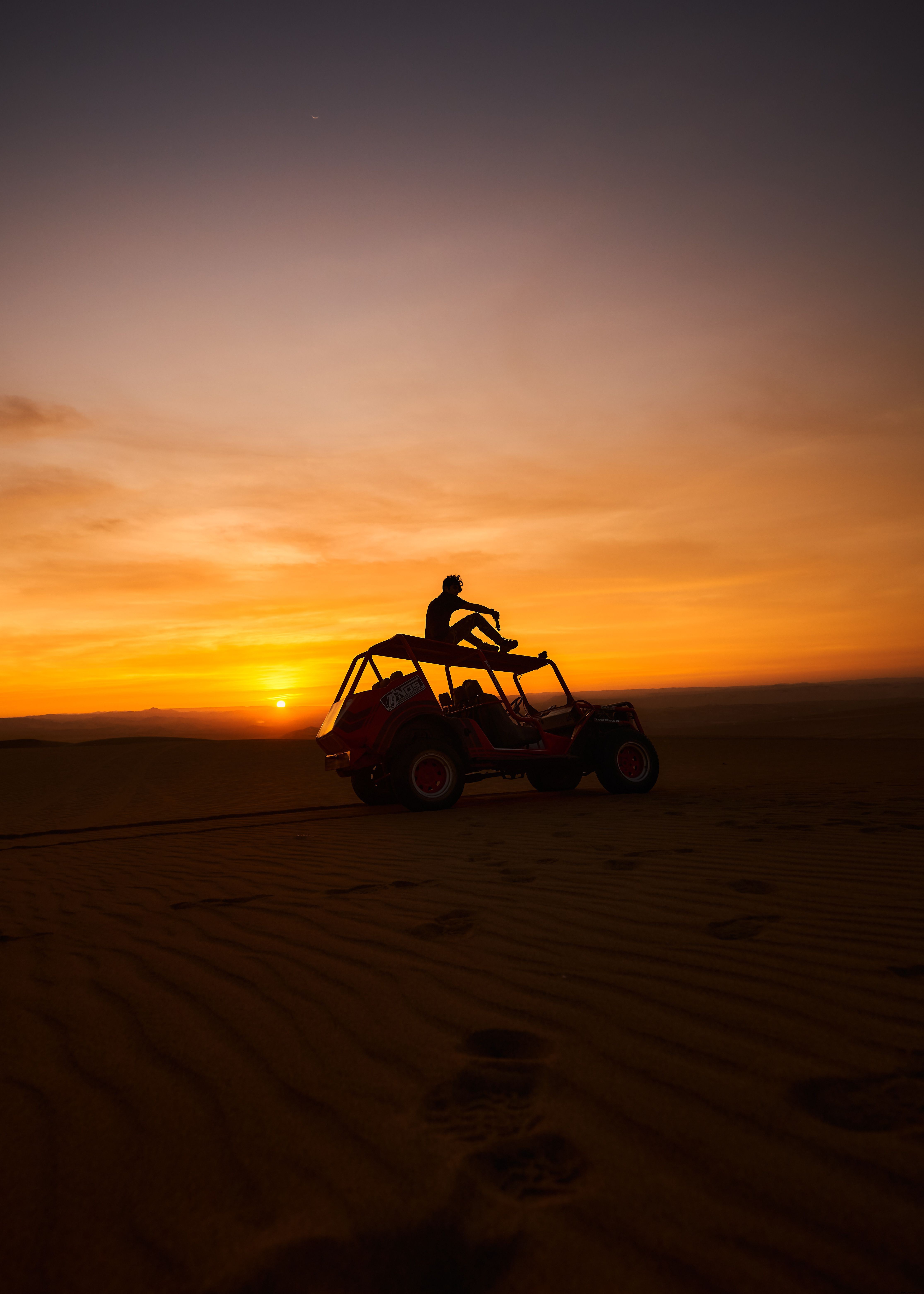 Stunning Dune Buggy Silhouetted Against a Vibrant Setting Sun