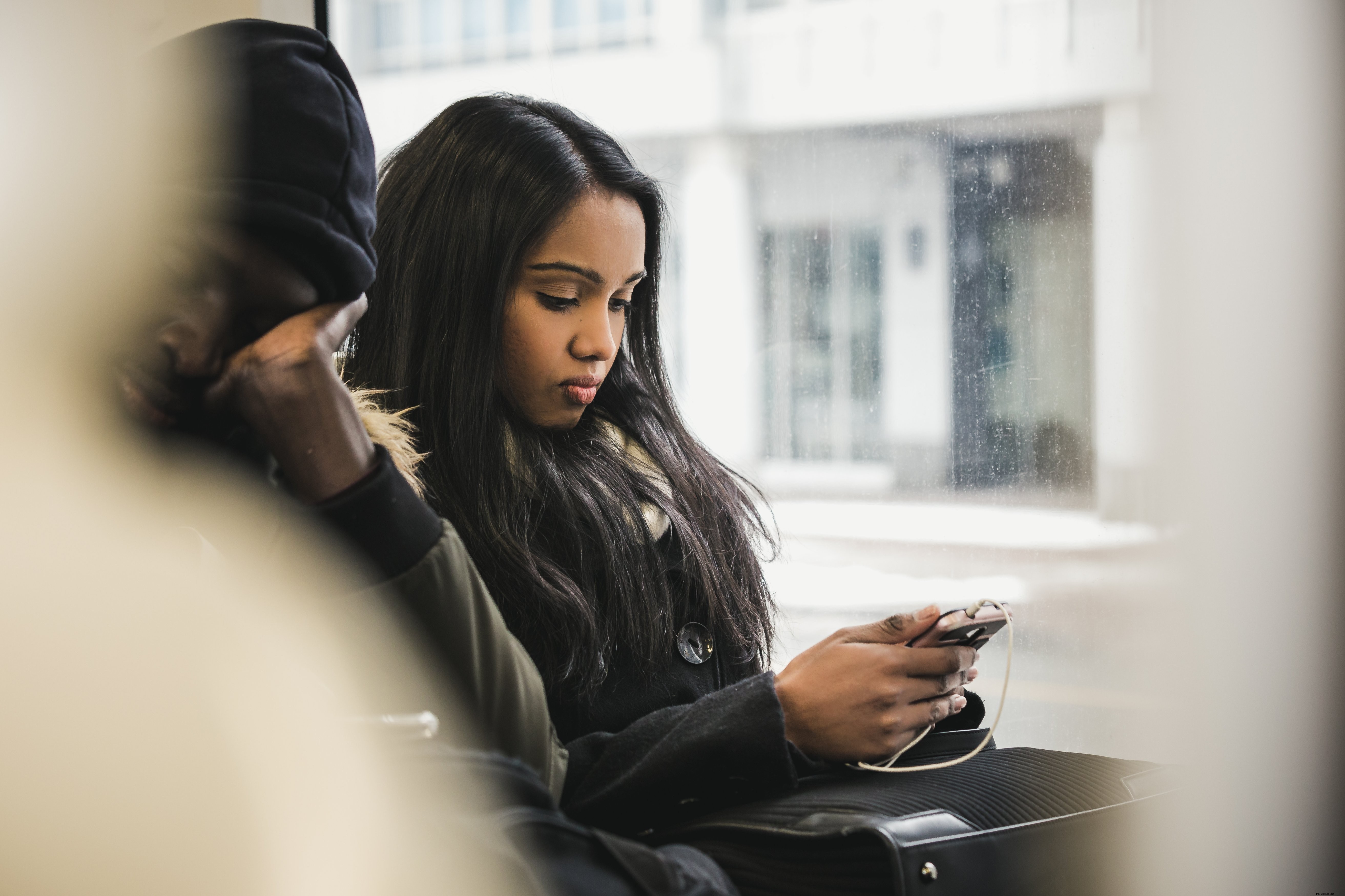 Stylish Woman Capturing Bus View with Smartphone