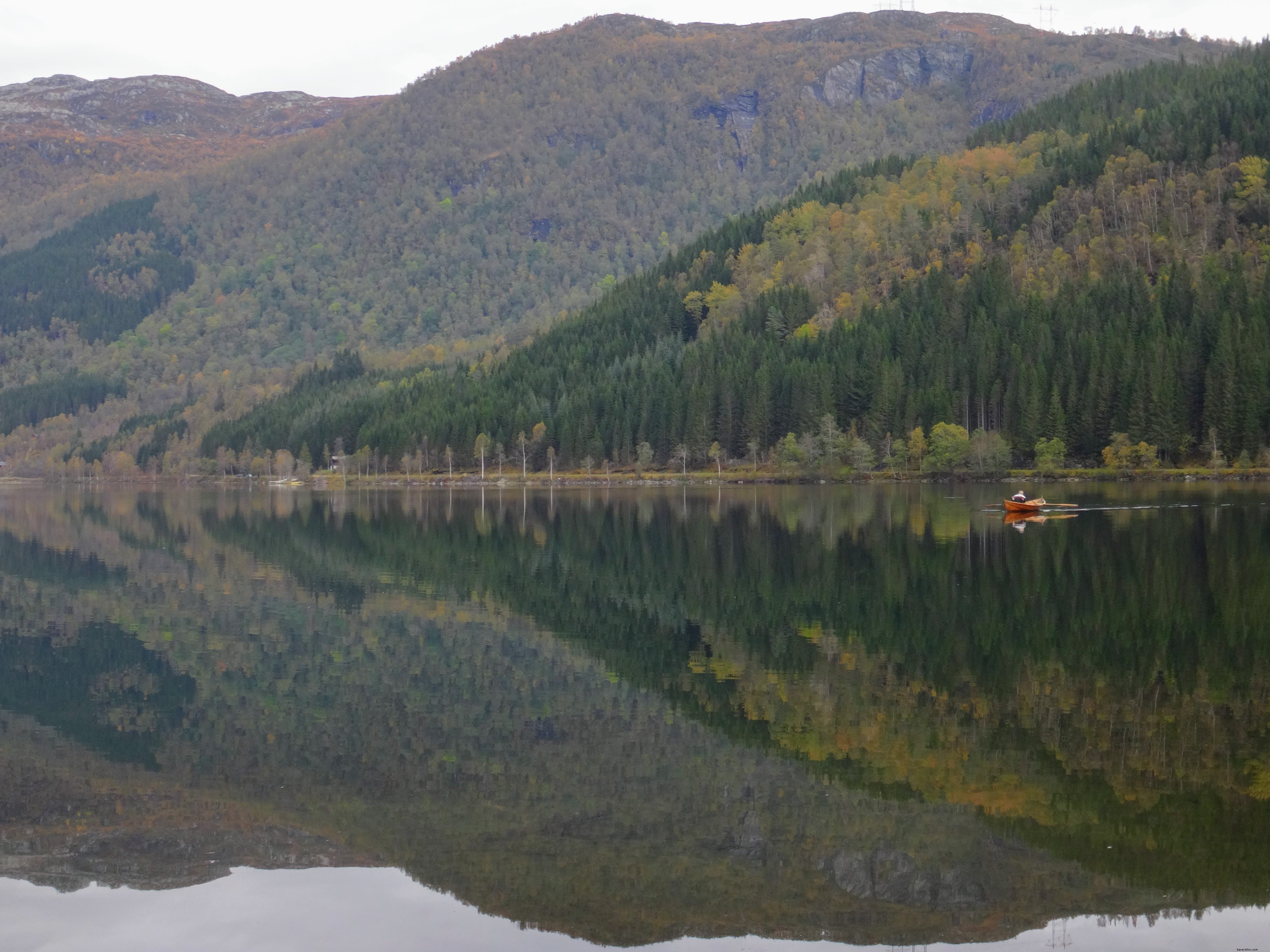 Serene Canoe on Calm Waters by Majestic Cliffs: Stunning Nature Photo
