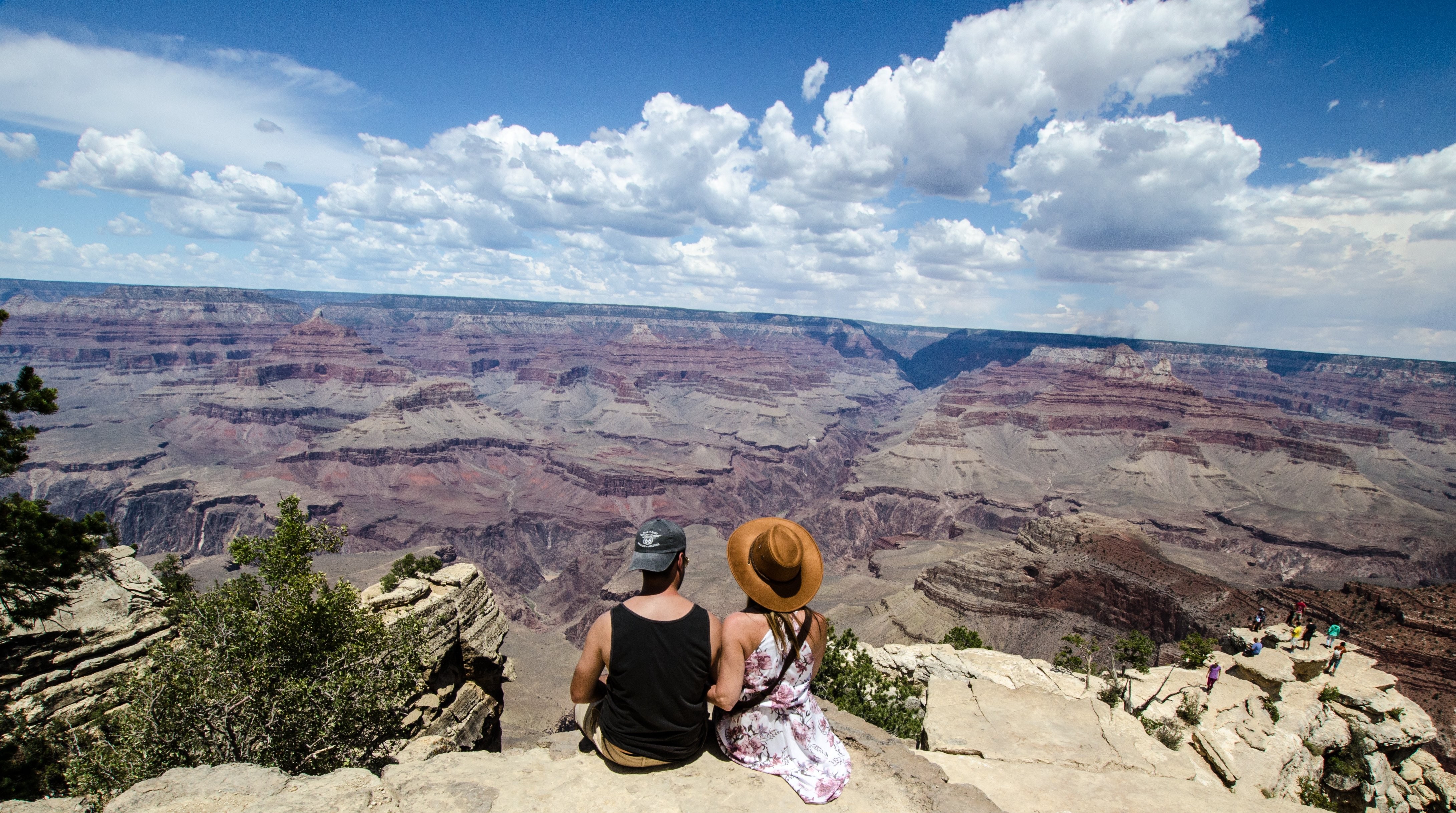 Young Couple Chatting Against Breathtaking Canyon Vista