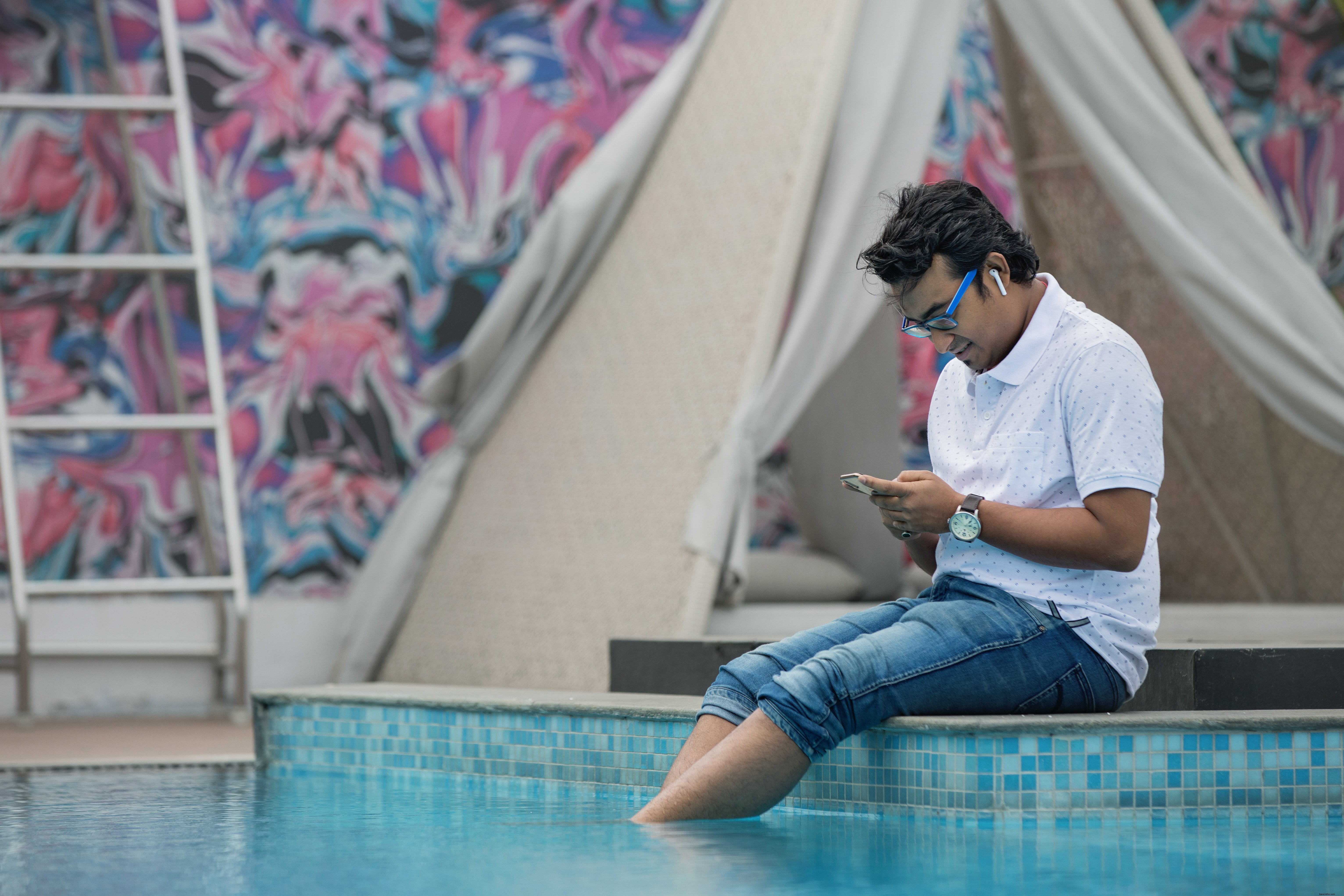 Serene Photo of Man Relaxing by the Poolside