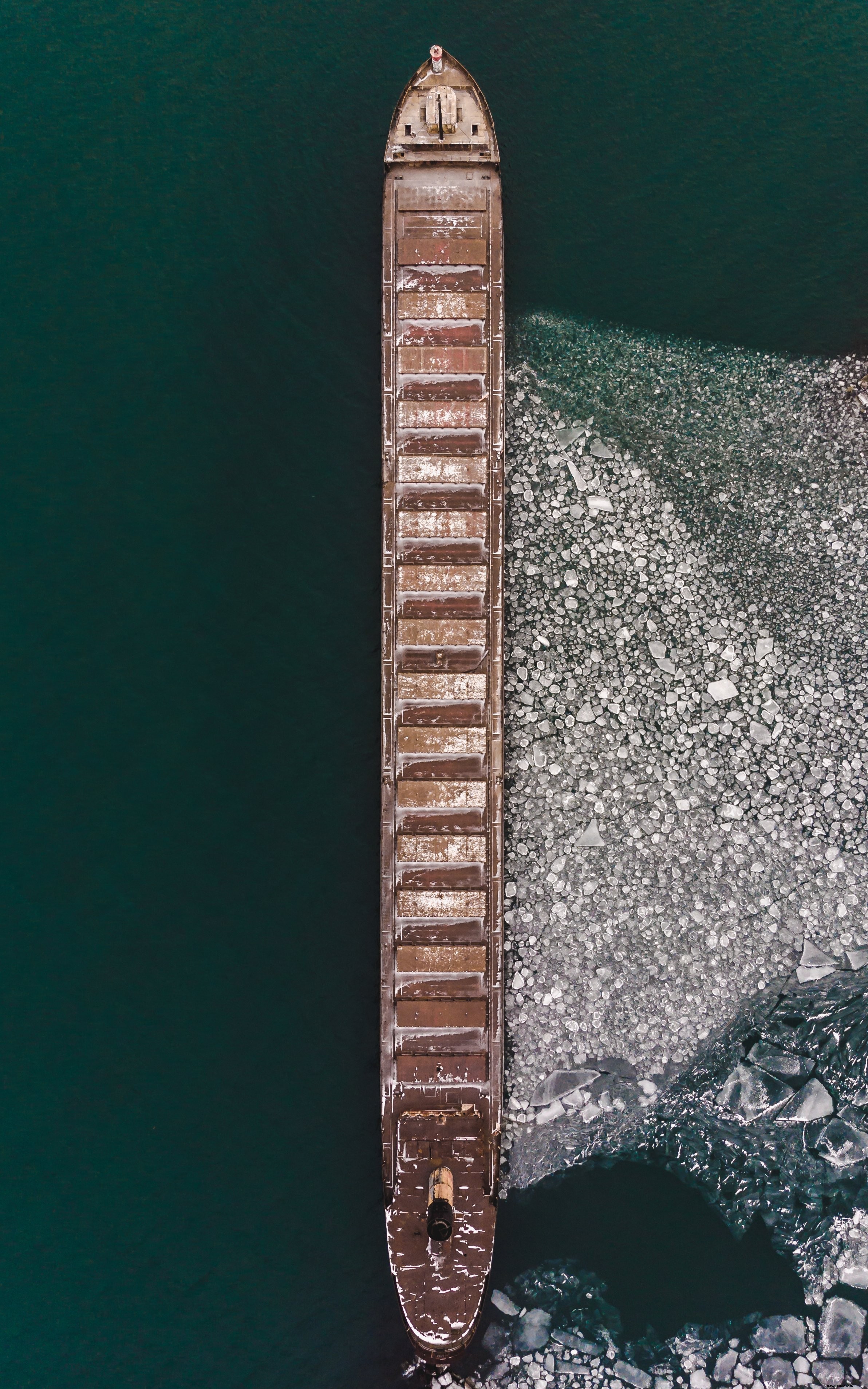 Stunning Vertical View: Ship Against Majestic Ice Landscape Photo