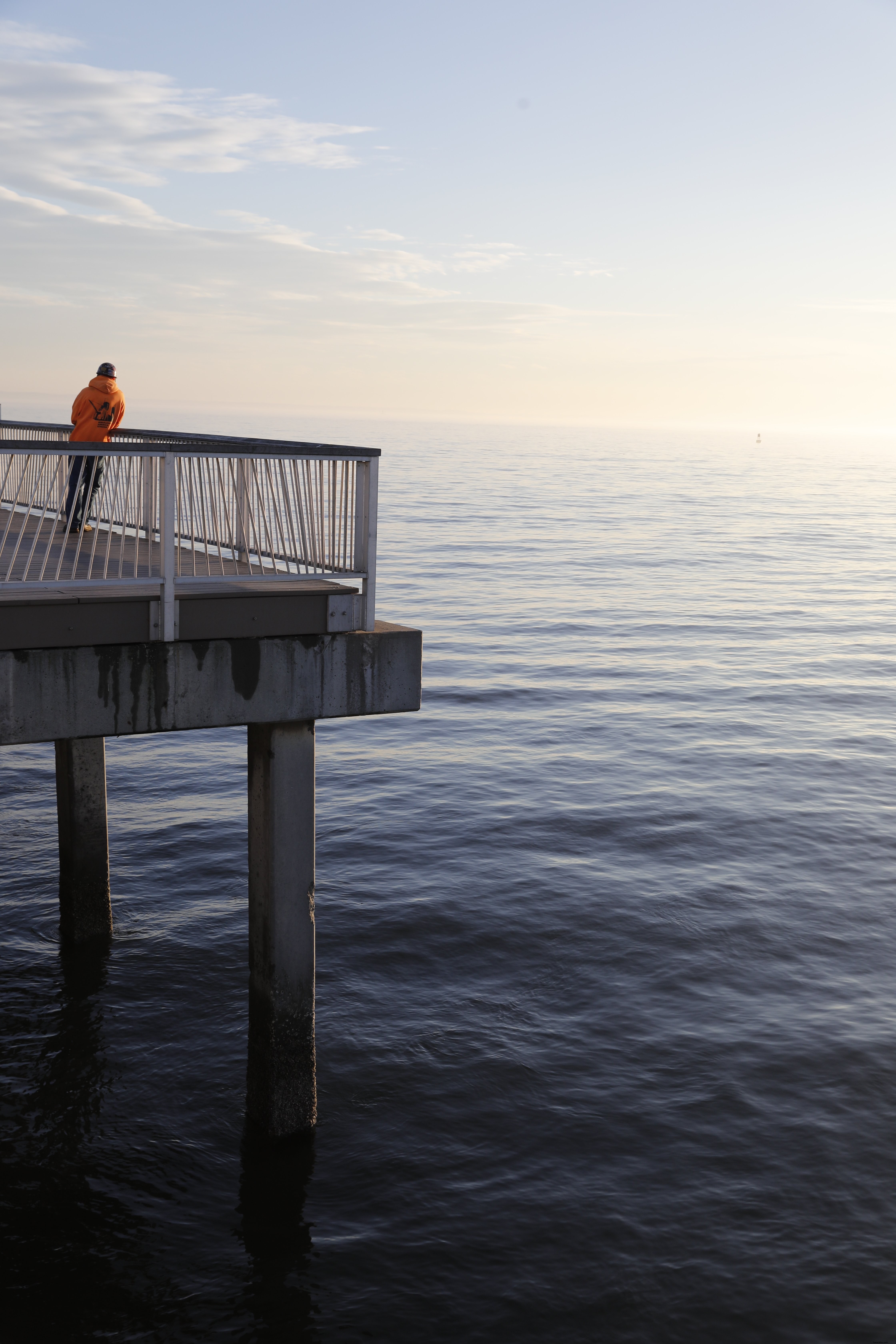 Serene Sunset: Lone Man on Pier – Stunning High-Resolution Photo