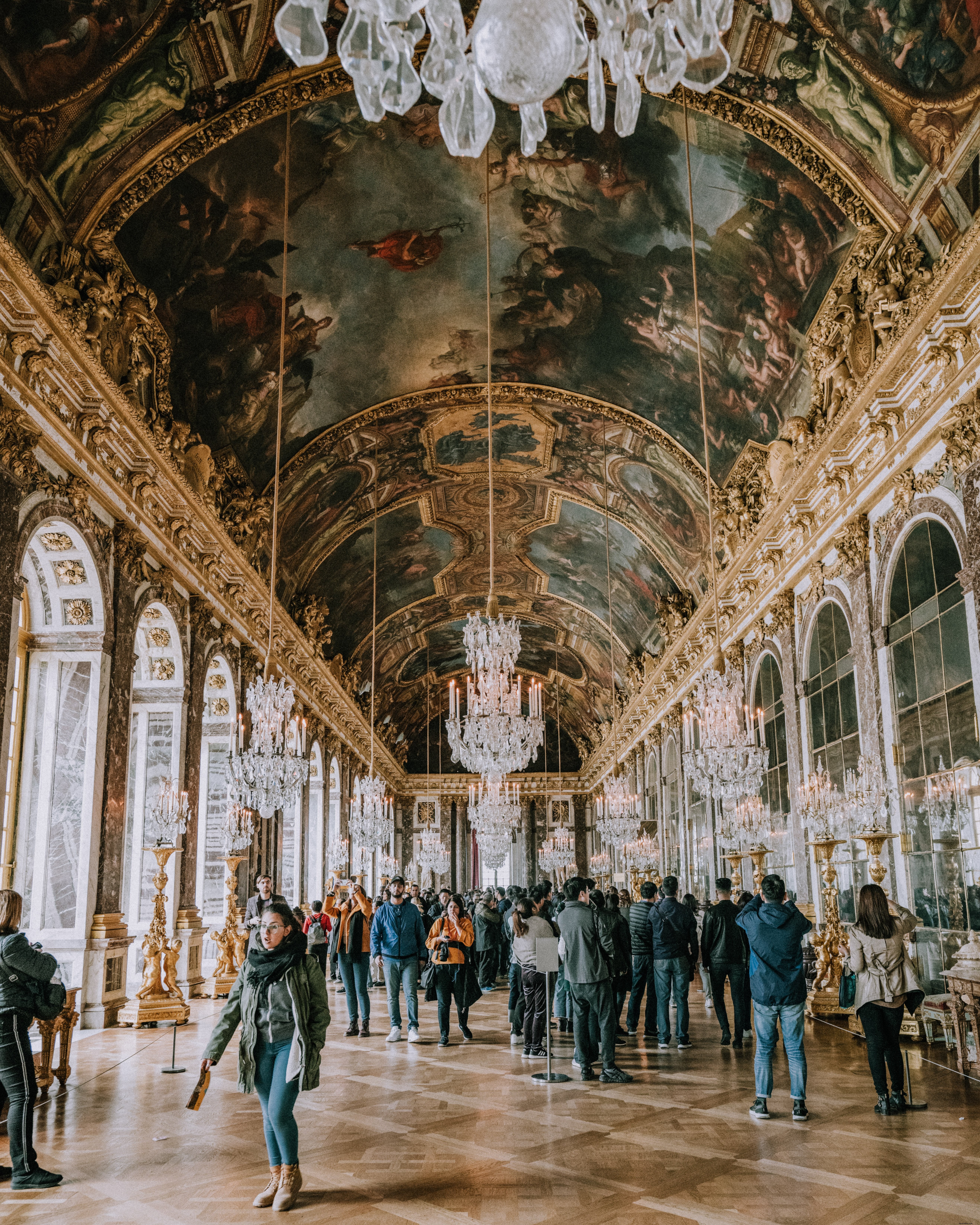 Iconic Photo: Tourists Admiring Grand Frescoes at Versailles Palace