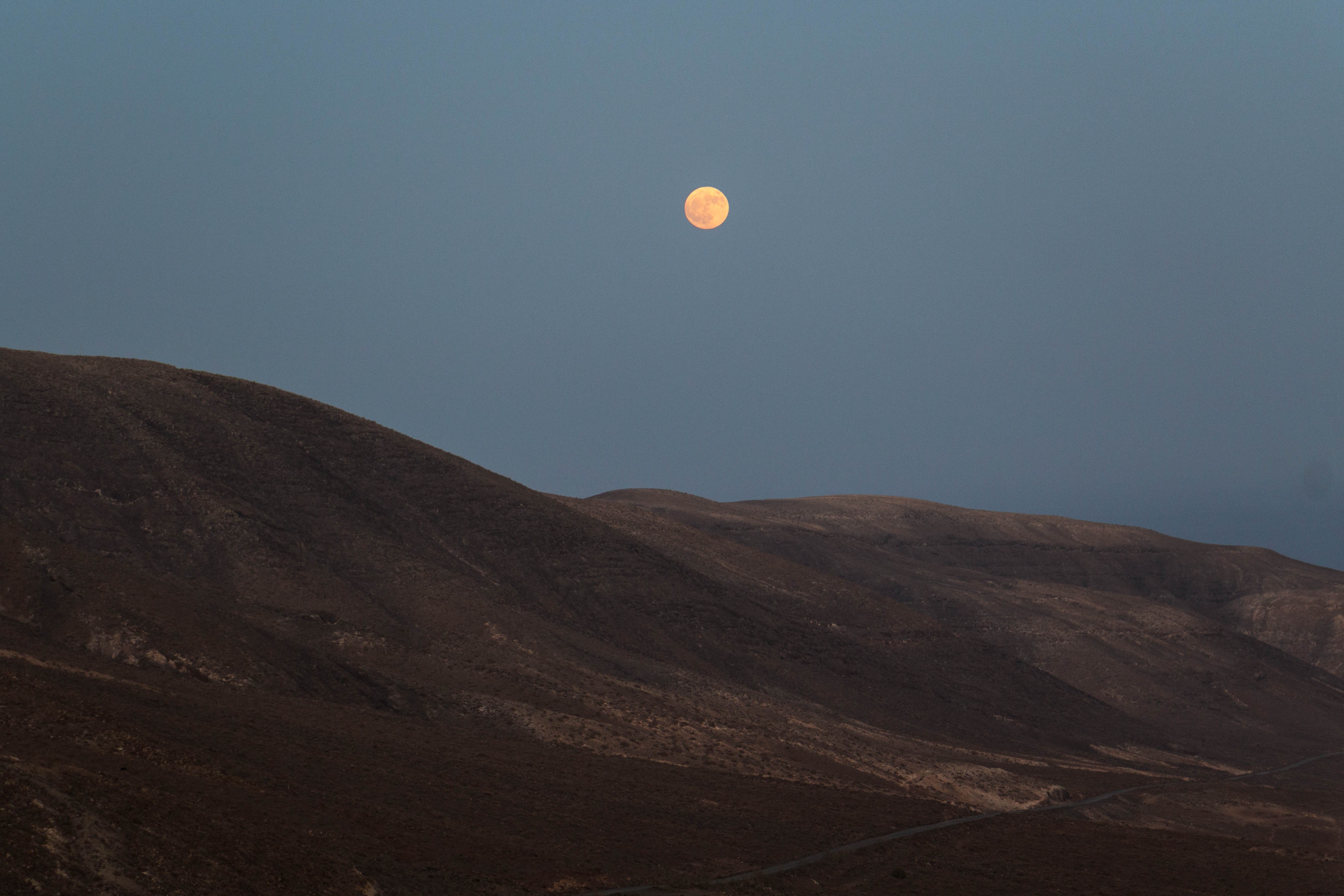 Stunning Full Harvest Moon Rising Over Picturesque Spanish Hillside – Captivating Photo